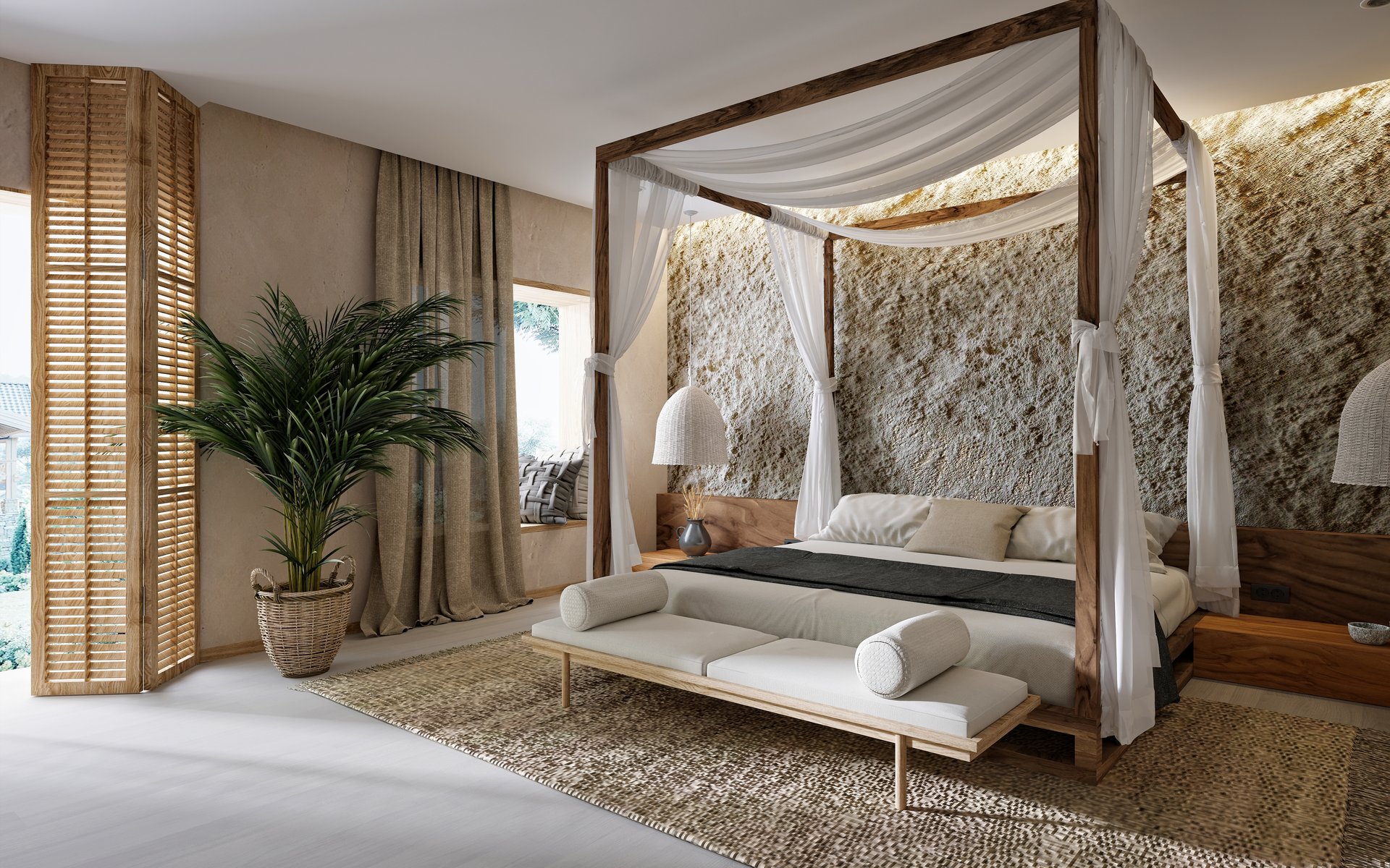 An elegantly designed bedroom with a canopy bed at its center. The wooden-framed bed is adorned with white drapes, creating a soft and cozy ambiance. On the bed are white and beige pillows paired with a dark gray blanket, adding contrast to the light color scheme. A bench sits at the foot of the bed, topped with two cylindrical pillows. The wall behind the bed is textured, resembling stone, which introduces a rustic and natural feel to the modern design.