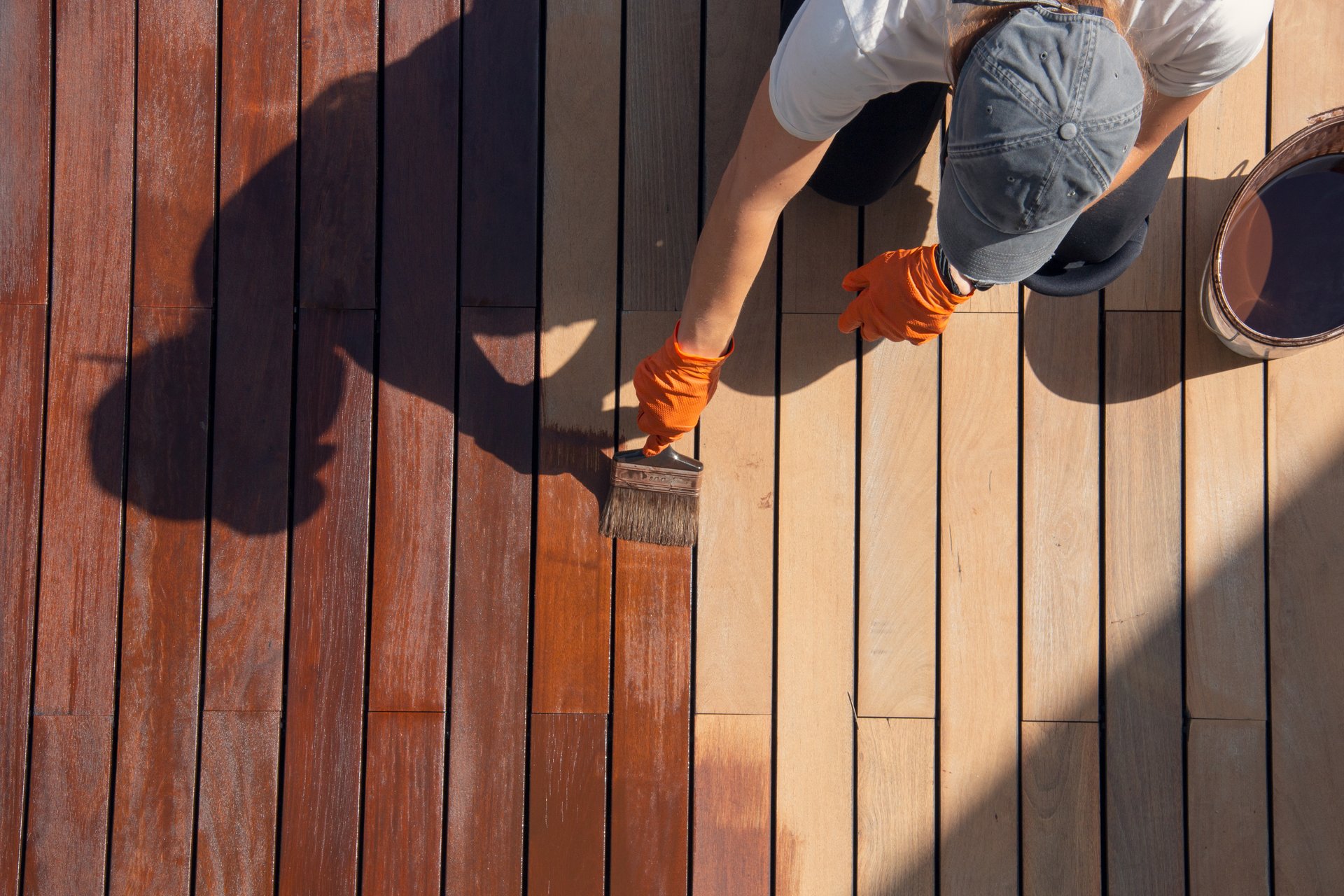 Applying premium UV-resistant stain to deck surface