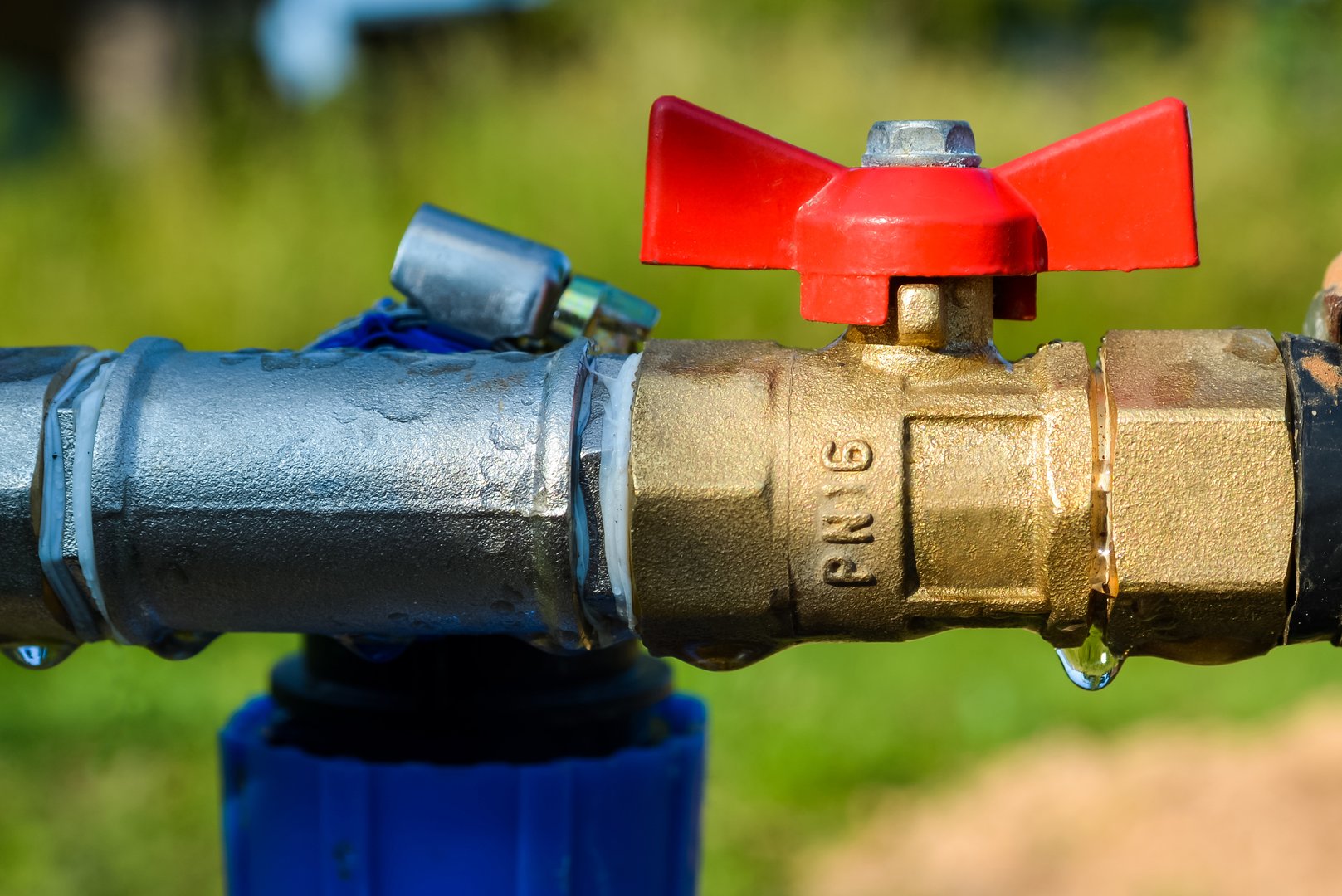 Water valve with red knob close up