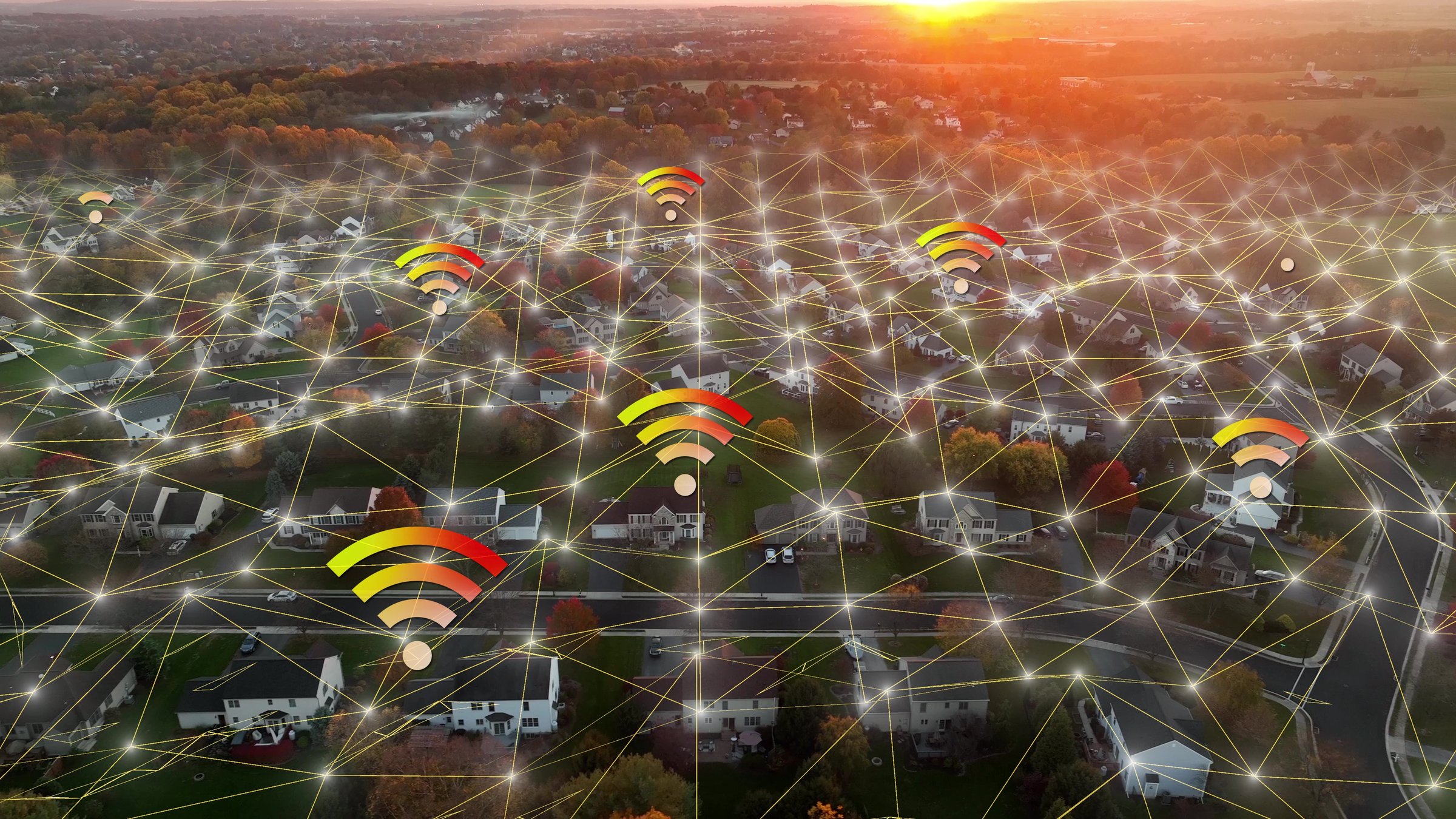 Technology connection over American suburb. 3D graphic of a neighborhood overlaid with WiFi symbols and network lines during golden hour sunset in autumn. Aerial