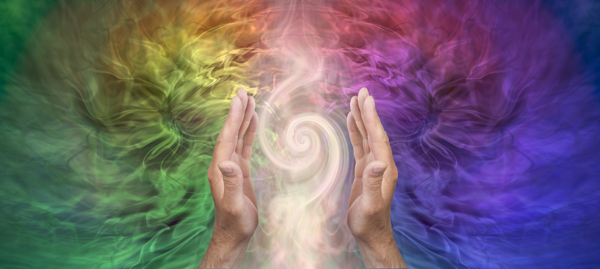 male hands sensing vortex energy in a full spectrum energy field with space for spiritual message