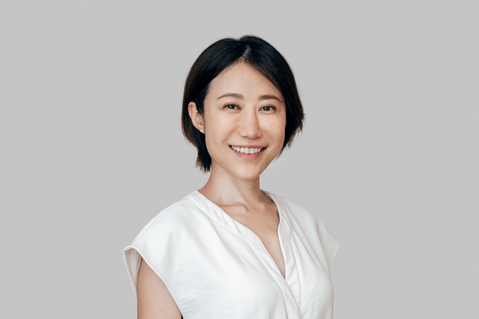 Smiling eastern sophisticated female entrepreneur ceo leader businesswoman isolated. Closeup headshot face portrait of mature Asian executive office manager business woman looking confident at camera