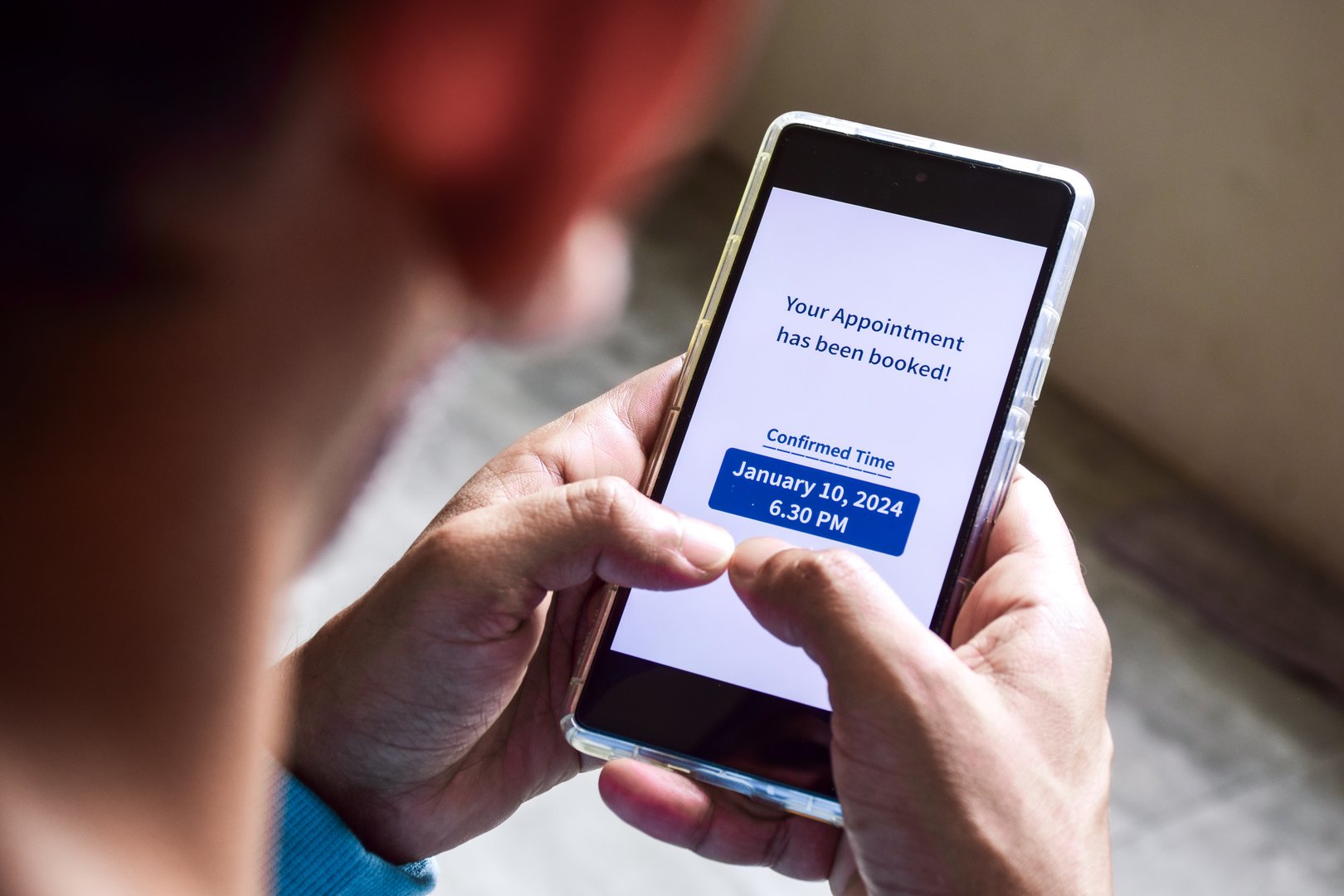 A South Asian man checking smartphone notification for his upcoming appointment. Online appointment booking and scheduling concept.