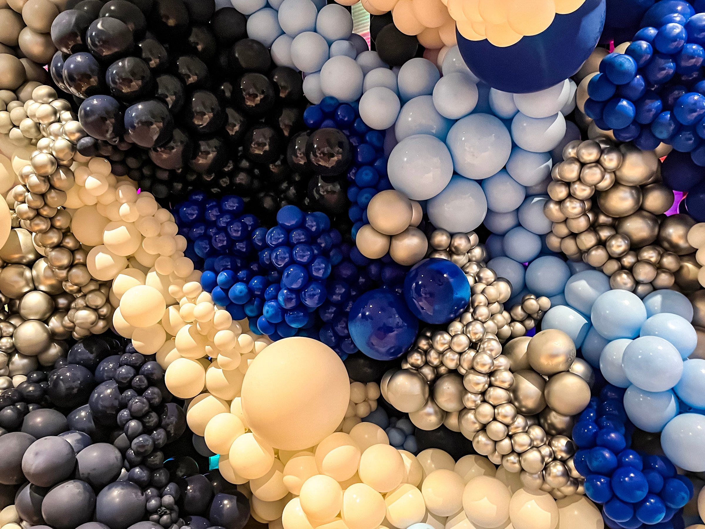 A wall of colorful balloons