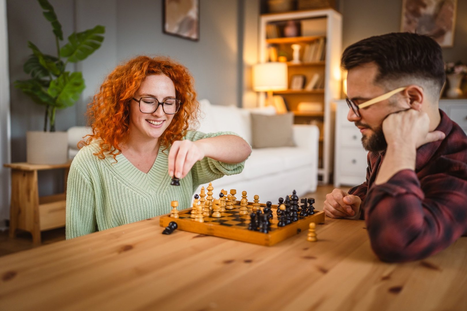 Couple playing chess together