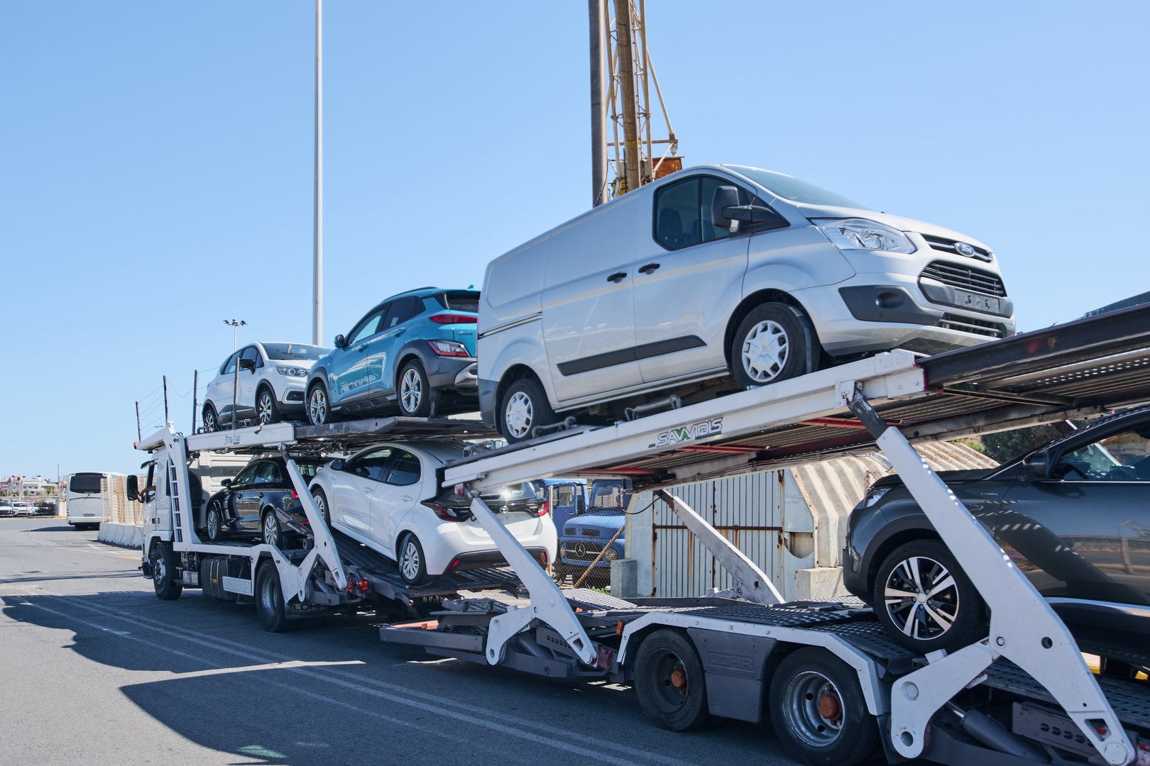 Crete.Greece - may 05, 2025: A multi-level vehicle transporter truck branded SAVALIS with cars securely positioned in two rows, demonstrating efficiency in logistics and automotive transportation.
