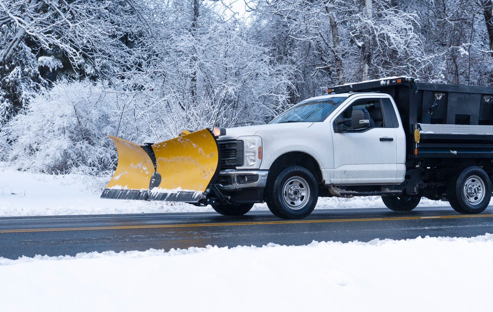 Truck with snowplow clearing snow