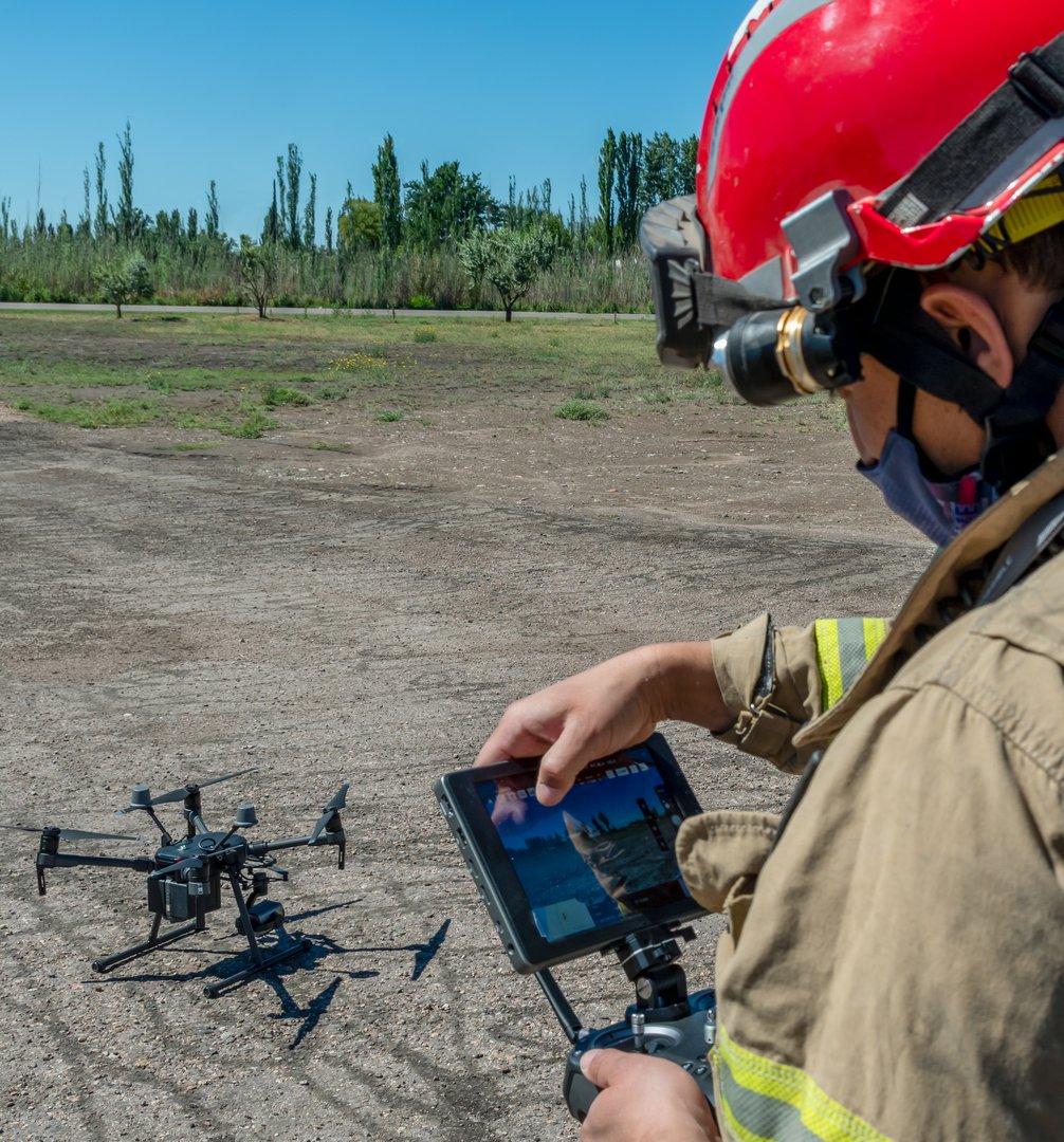 Firefighter operating rescue drone in training during daylight
