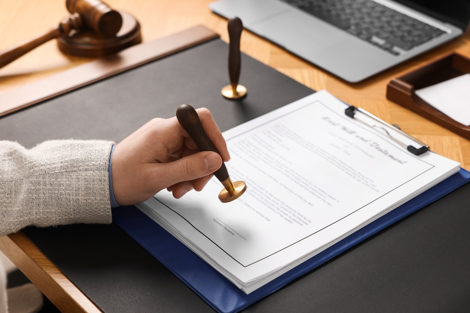 Notary stamping document at table