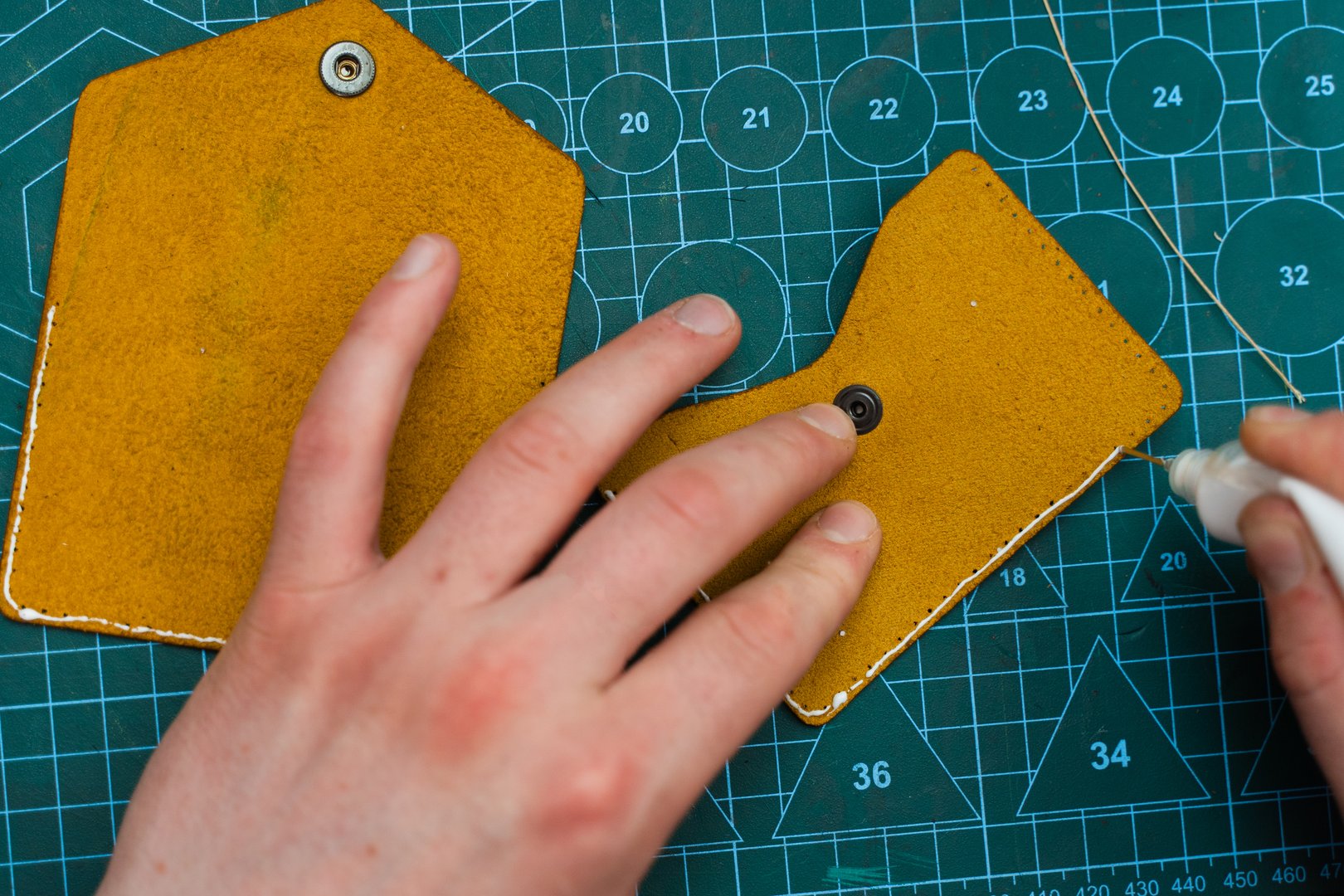 Applying Glue to Leather Edges. Crafting leather goods starts with applying strong adhesive to bond edges securely. Leather artisans use glue to prepare edges before stitching