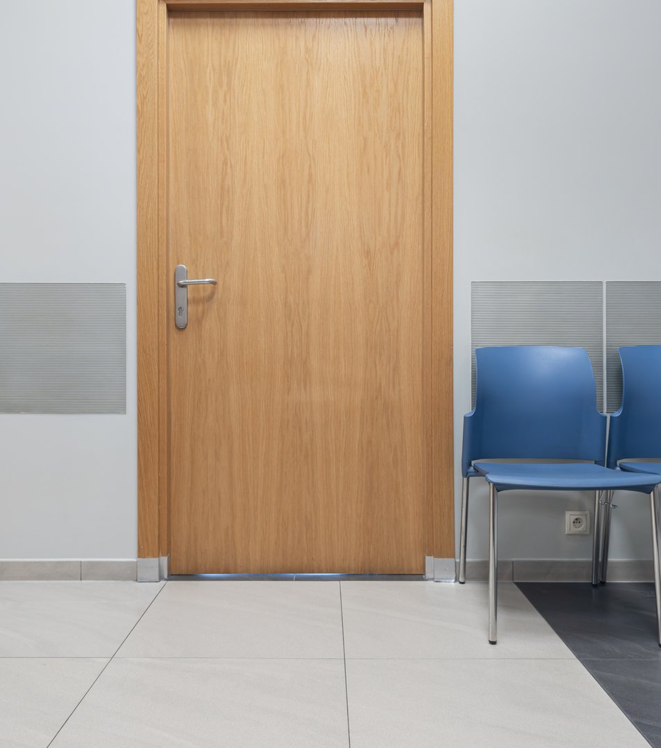 Waiting room, chairs in front of the office, closed door
