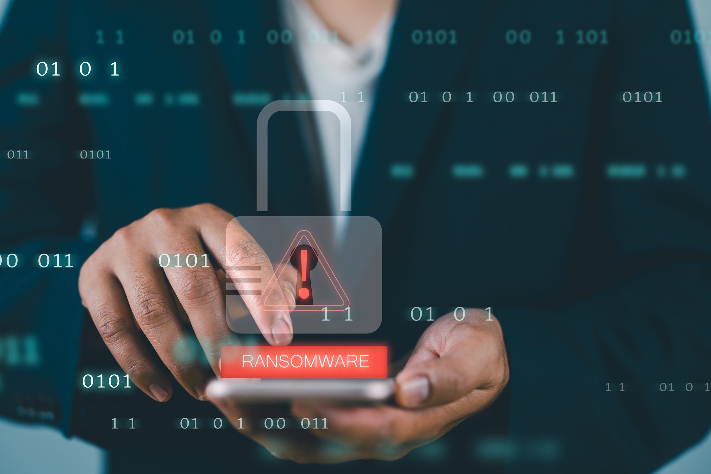 Malware attack virus alert. Person use smartphone with virtual warning sign with ransomware word. Warning notification, Cyber threats.