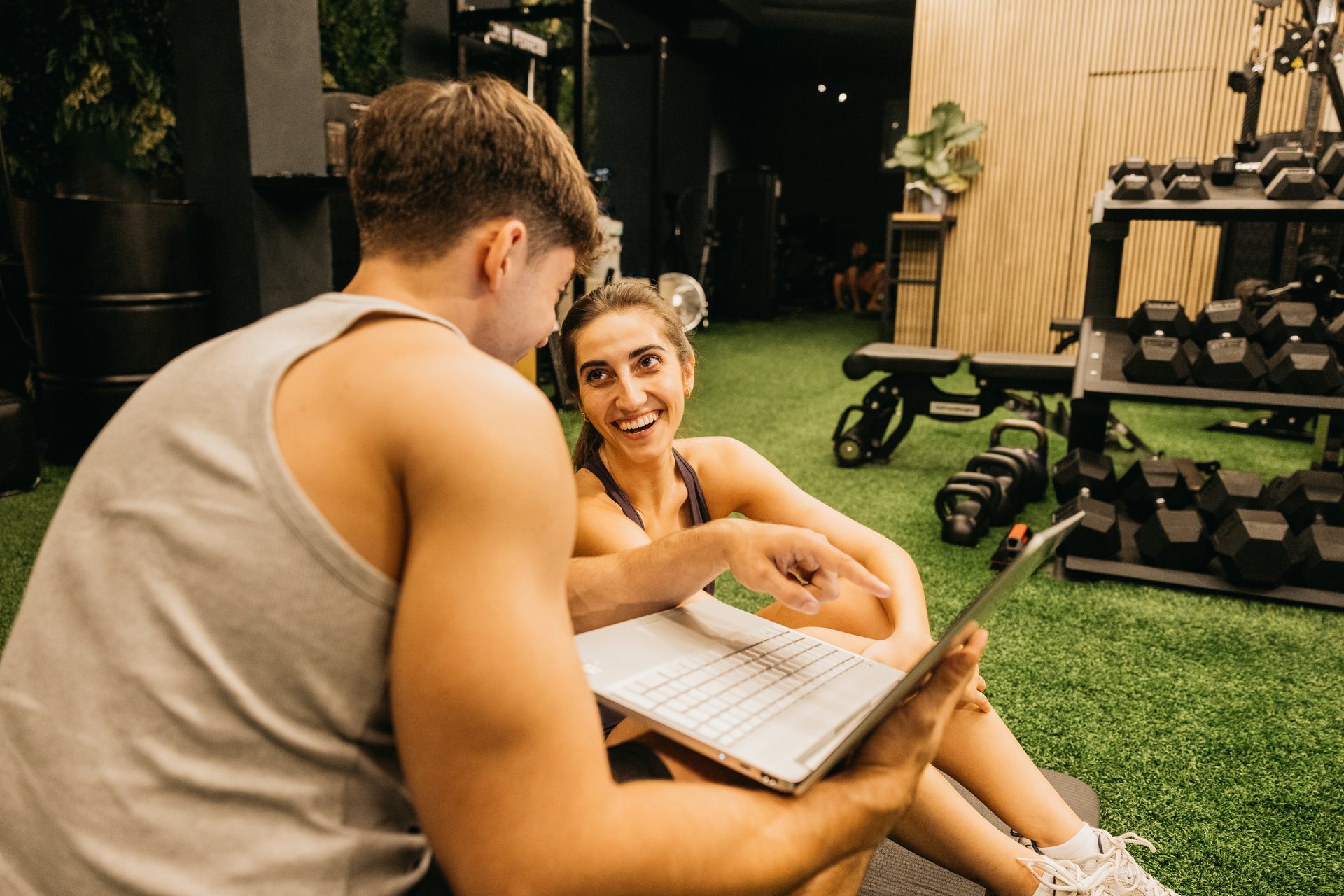 A young couple at the gym with workout equipment