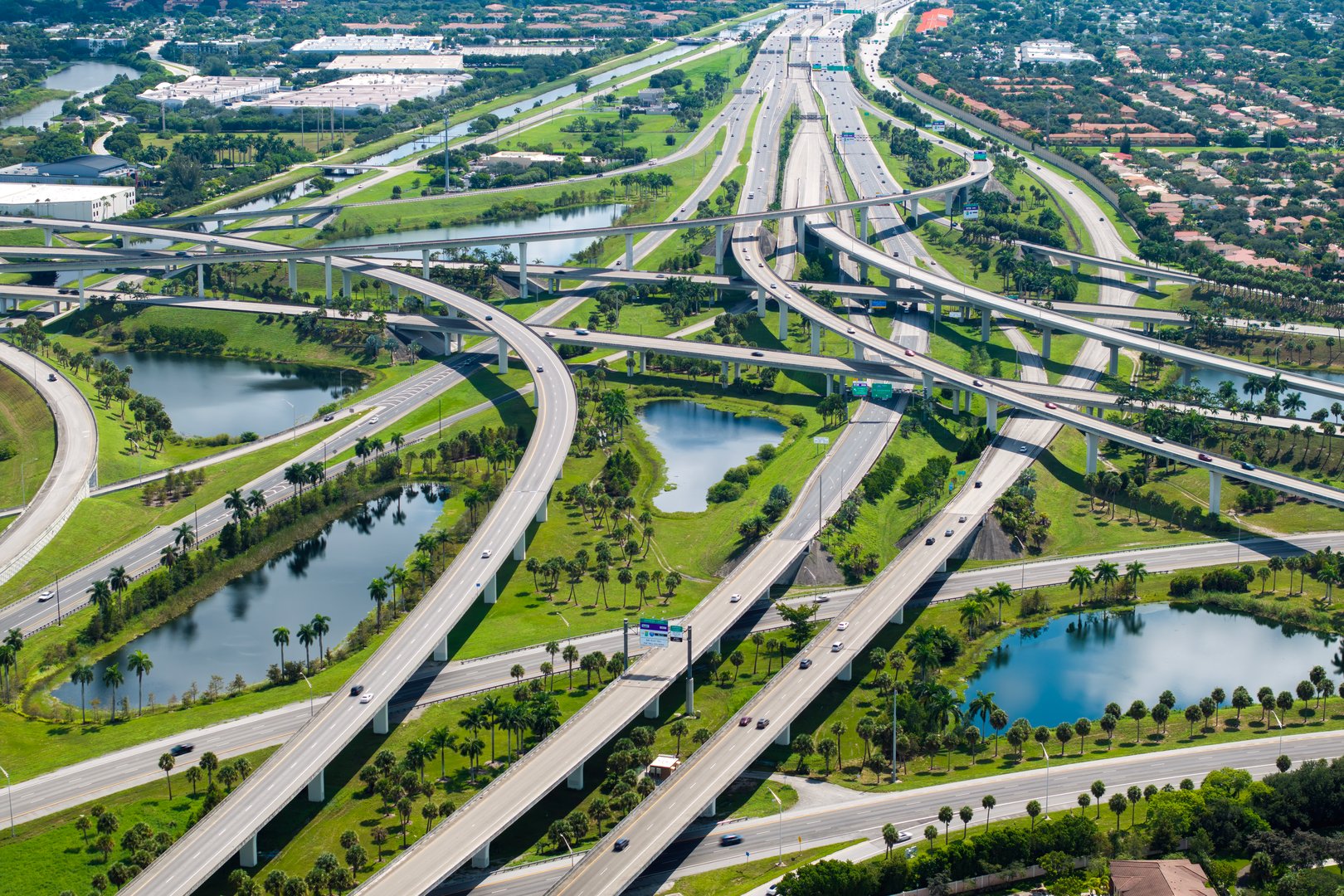 Aerial view of American freeway intersection with fast driving cars and trucks in Miami, Florida. USA city transportation infrastructure.