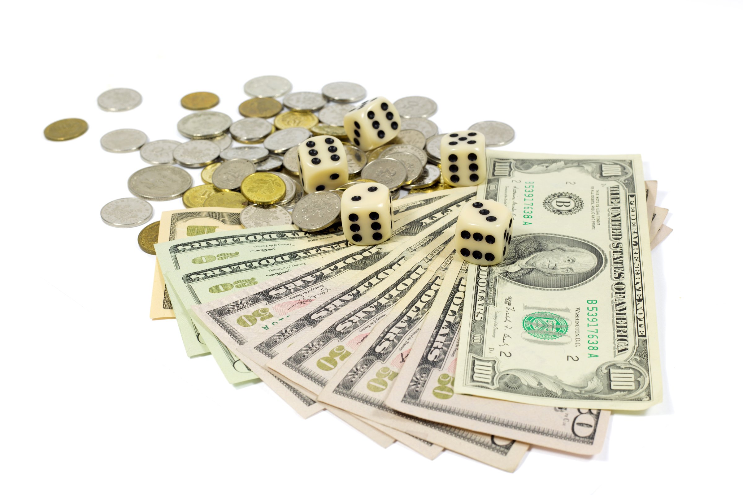 White Dices on American Dollar Bills and Coins Isolated on White Background