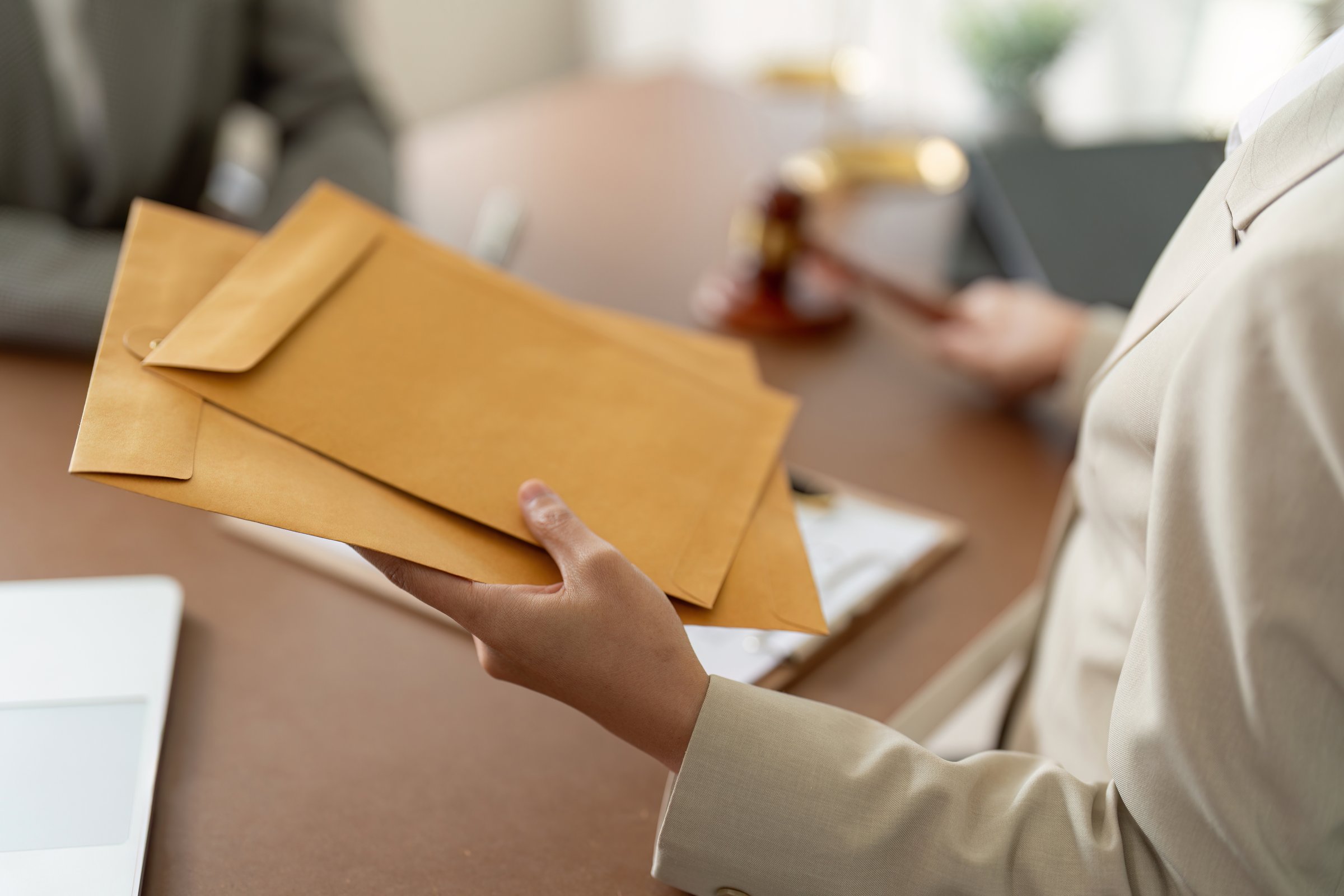 A legal advisor delivering documents to a client, highlighting confidential legal exchange and professional service.