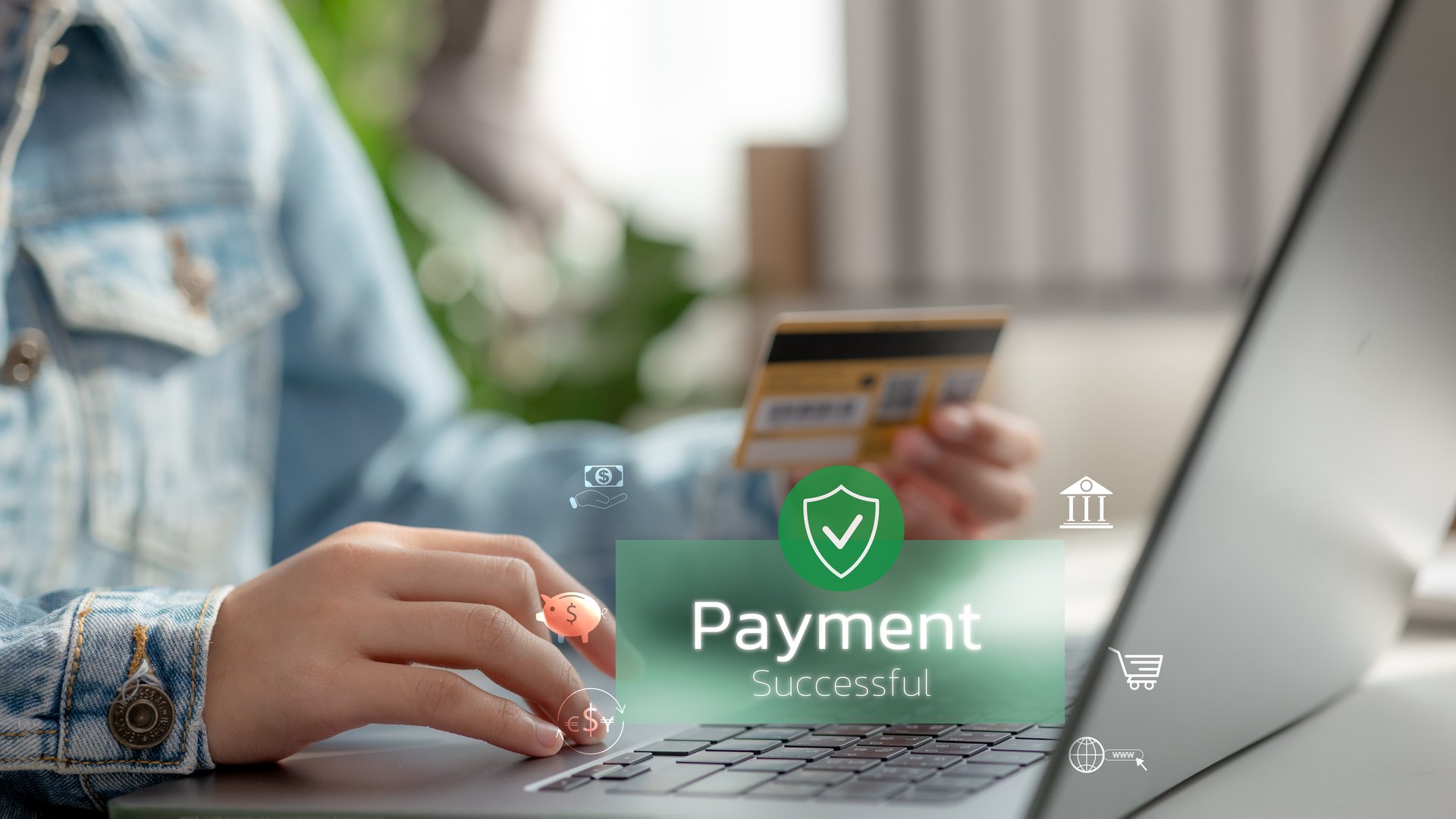 Close-up of hand holding credit card with "Payment Successful" notification on laptop. Concept of secure online transaction, e-commerce, digital banking, and internet payment confirmation.