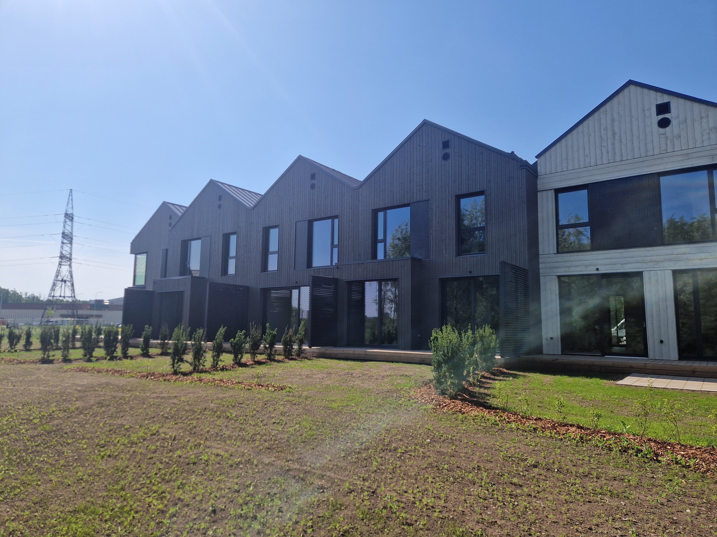 Construction project showing facade work, pergolas, and terraces
