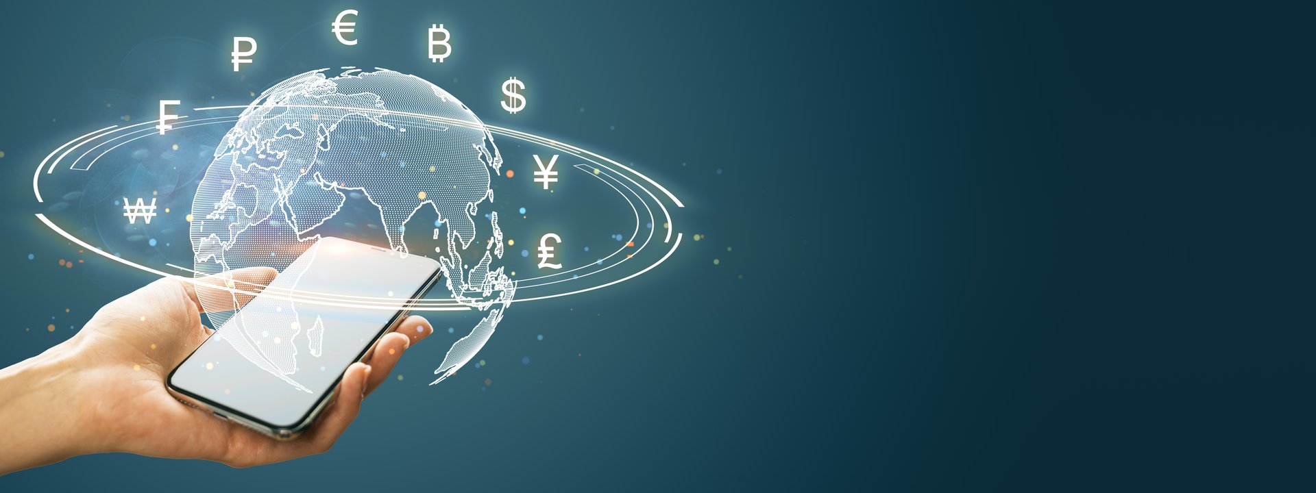 Hand holds smartphone with digital Earth and global currency symbols around it, on a dark background. Concept of global online finance