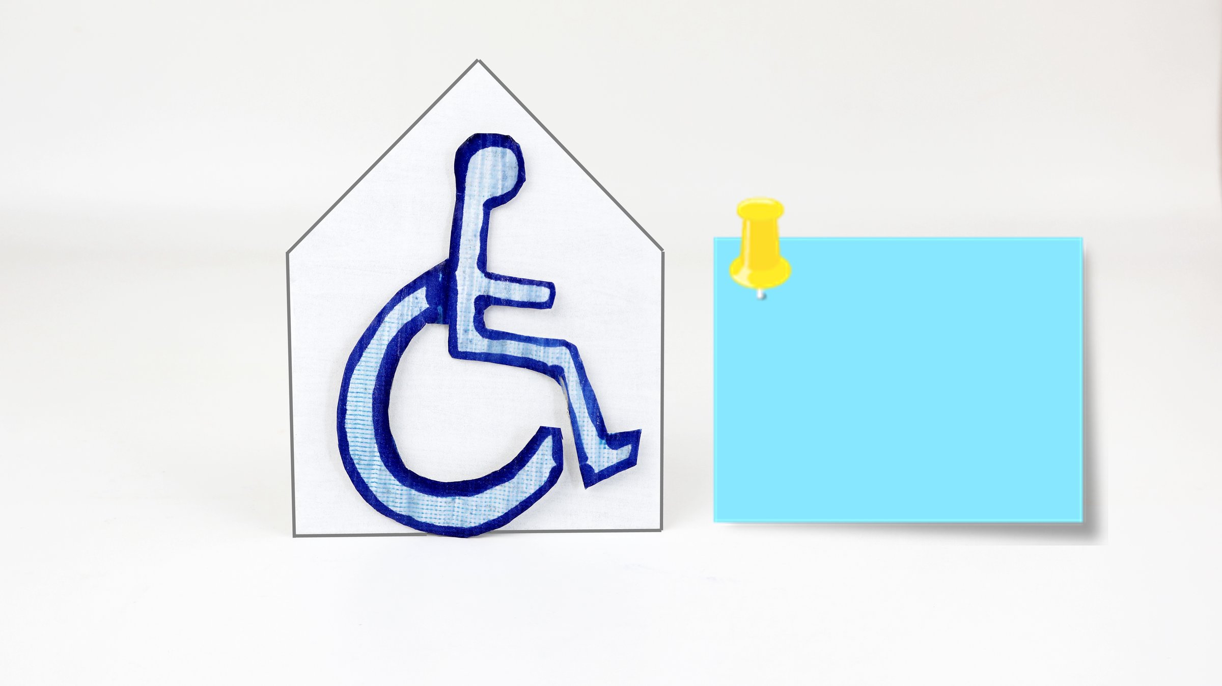 Wheelchair folded out of paper with origami style and post-it copy space.