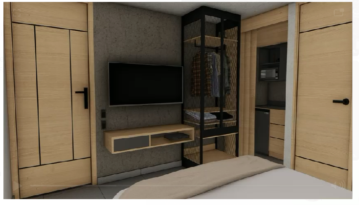 Modern minimalist bedroom with TV, open wardrobe, light wood furniture, and a glimpse of a small kitchenette.