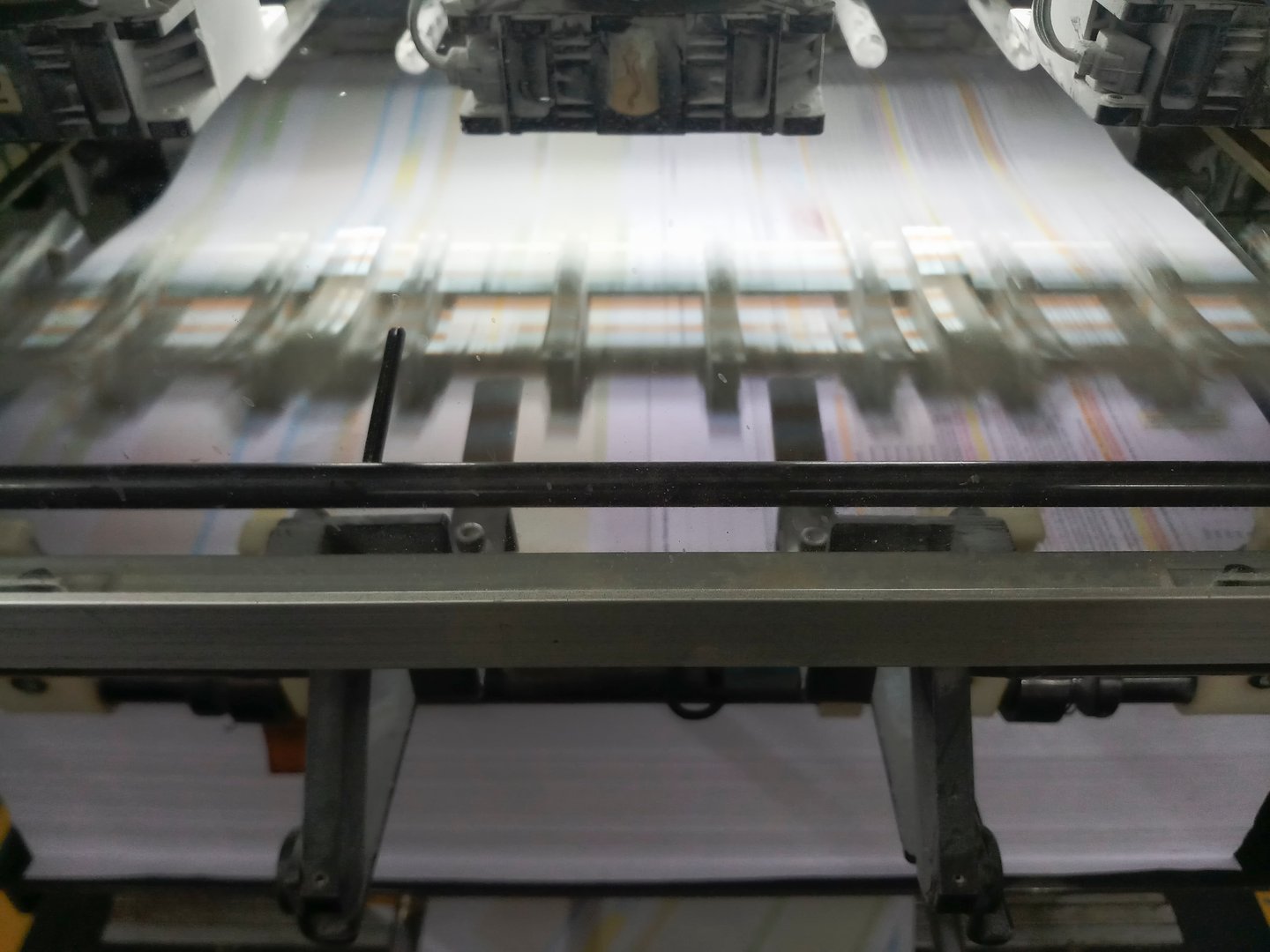 A modern four colour printing machine running in high speed. Shot at Kolkata, West Bengal, India.