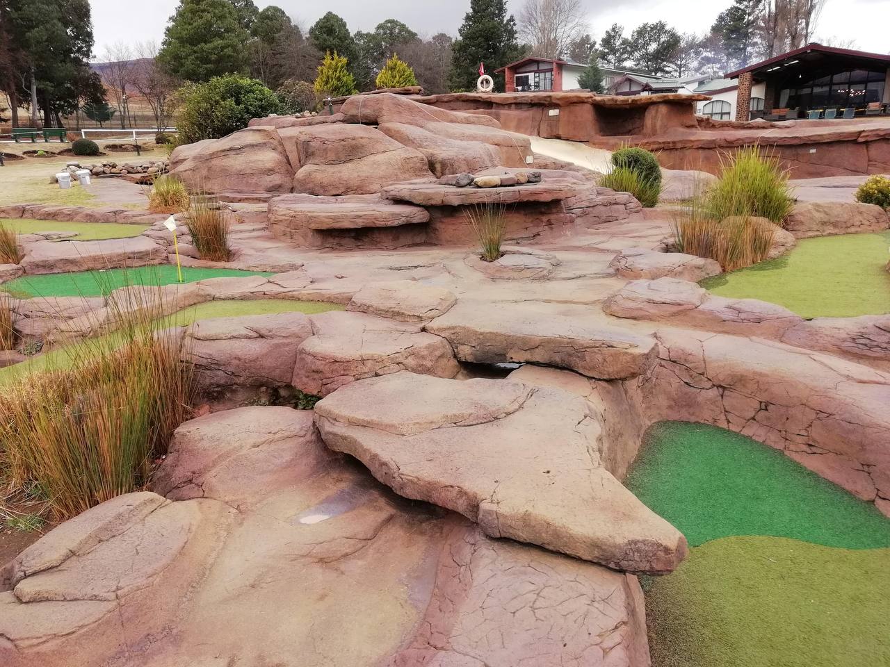 Modern style architecture exterior vacation villa with luxury swimming pool and tropical tree garden. Contemporary desert building design with poolside area and patio in backyard. Rich real estate rental. 3d rendering.