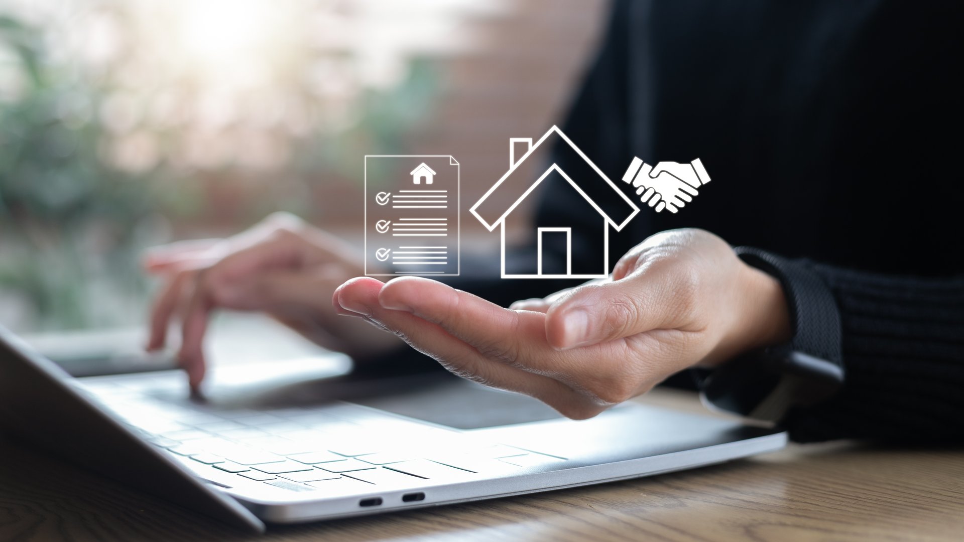Closeup hand holding digital house contract icon with handshake, concept of online property transaction, smart real estate, and digital housing agreement.
