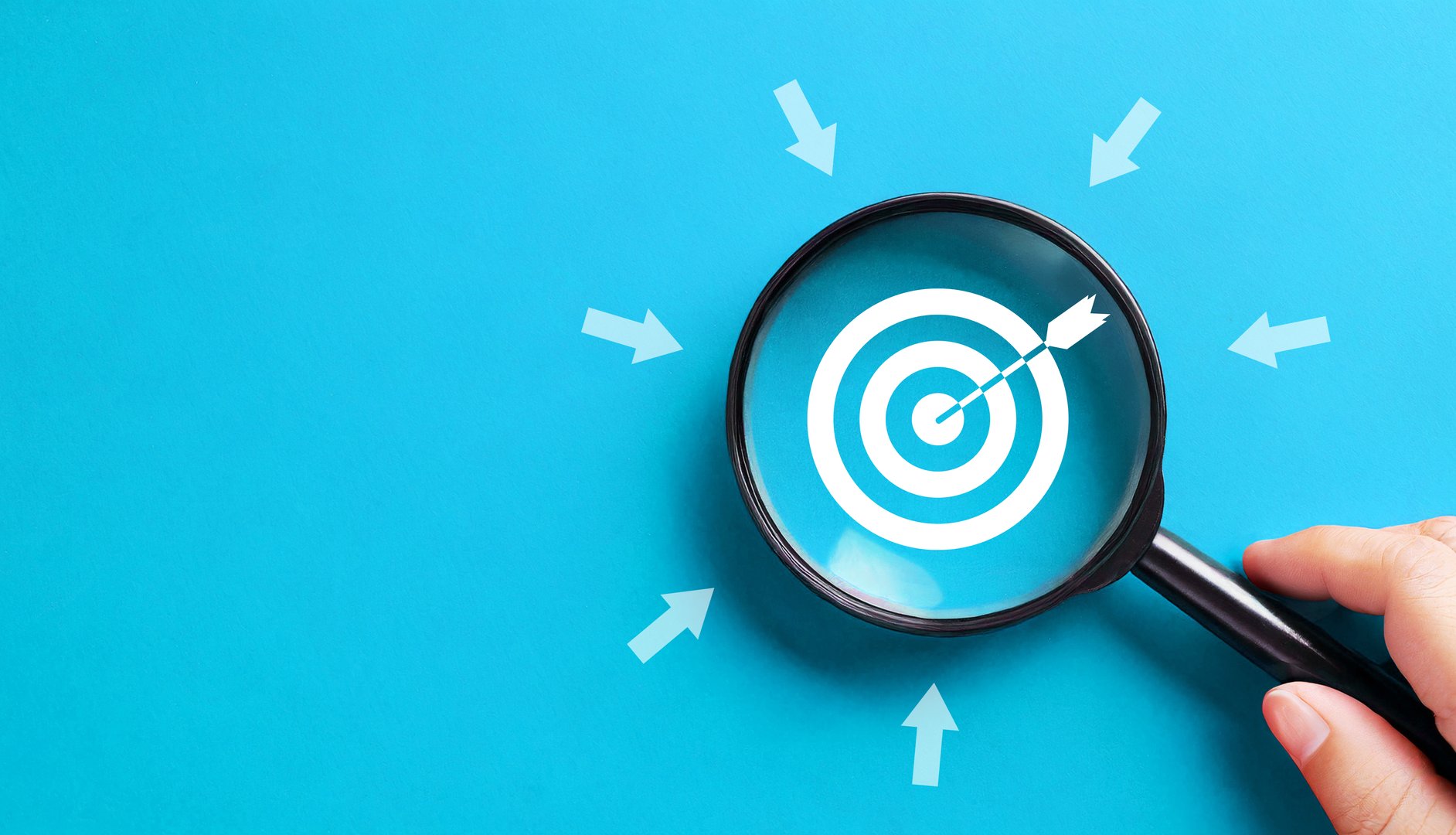 Business target concept with magnifying glass on blue background. Business development, leadership and customer target group concept.