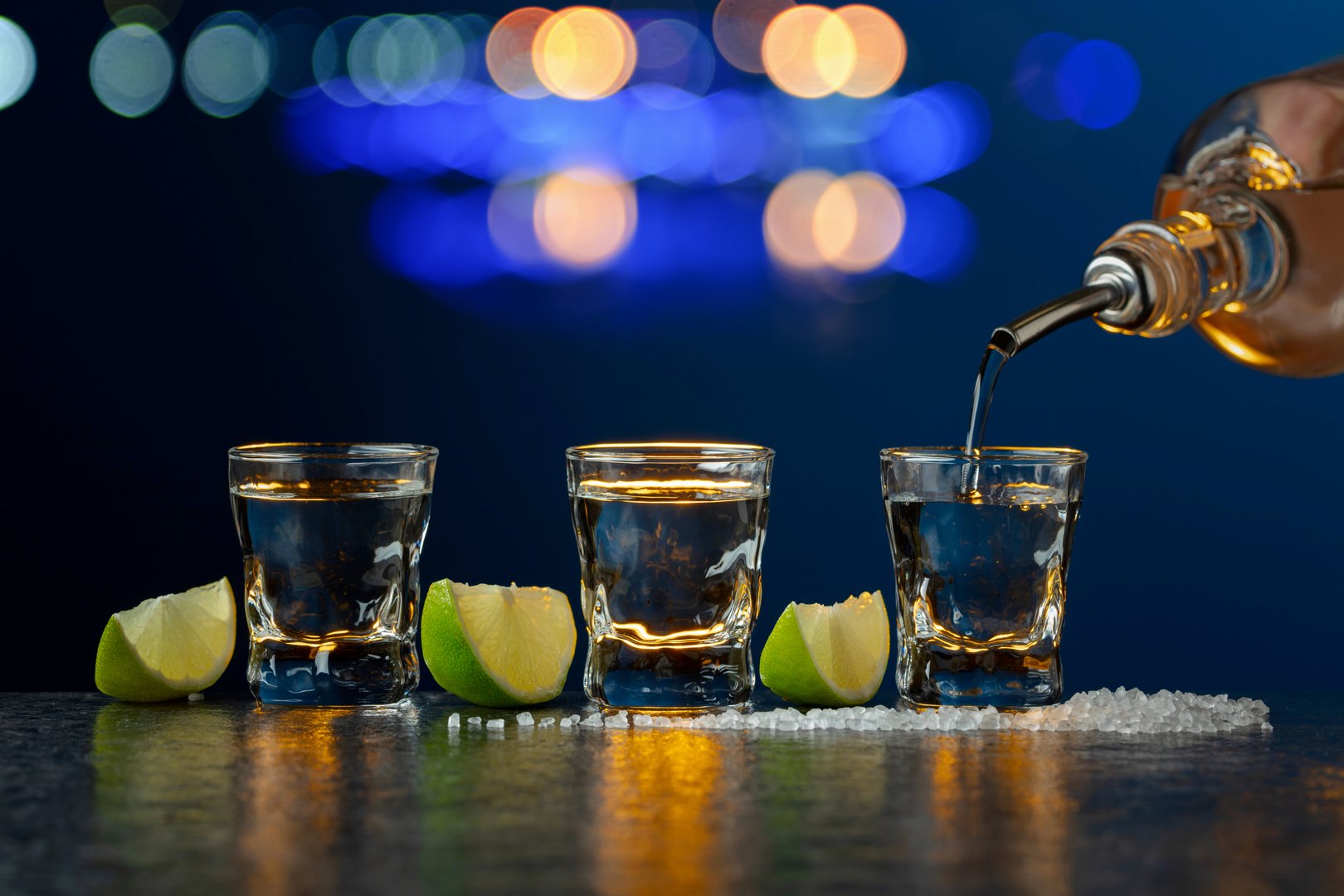 Mexican Tequila with lime and salt on a stone table