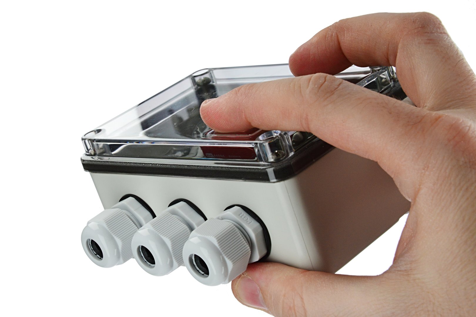 Electronic water level controller switch box with transparent top cover, held in left hand, white background