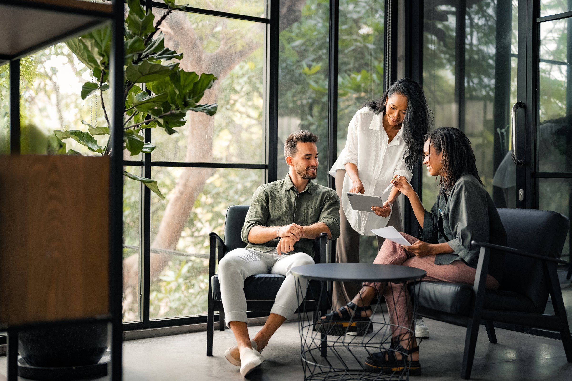 Group of busy happy diverse professional business team people working in office using digital tablet. Multiethnic young startup team working on a project together