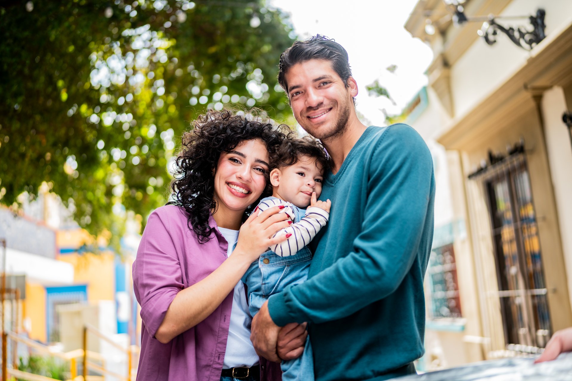 Portrait of young family with baby son outdoors