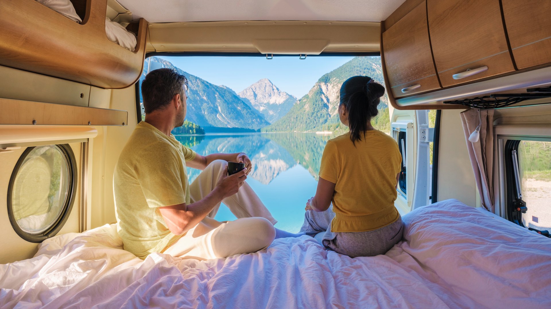 Couple in campervan with fjord view
