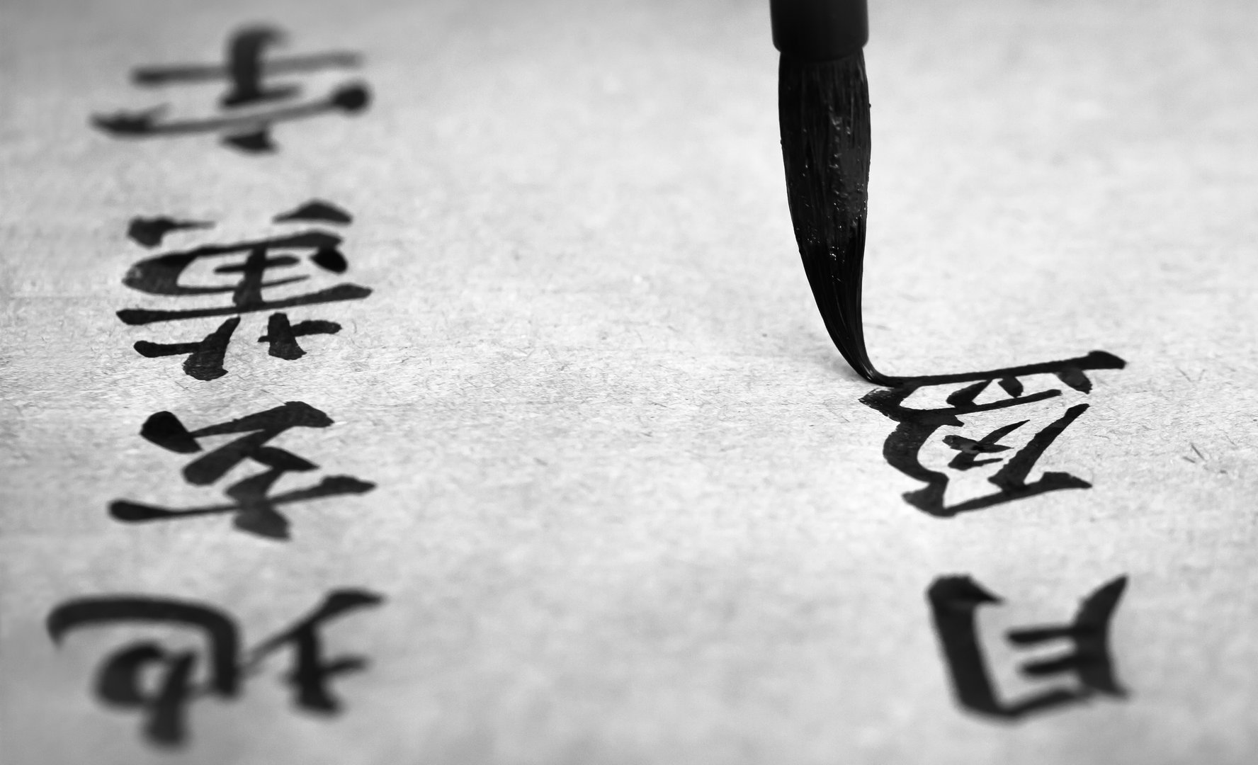 Text from ancient Chinese literature is painted on traditional paper. English translation of the entire text: The sky is black, the earth is yellow, and the universe is formed in the state of chaos.