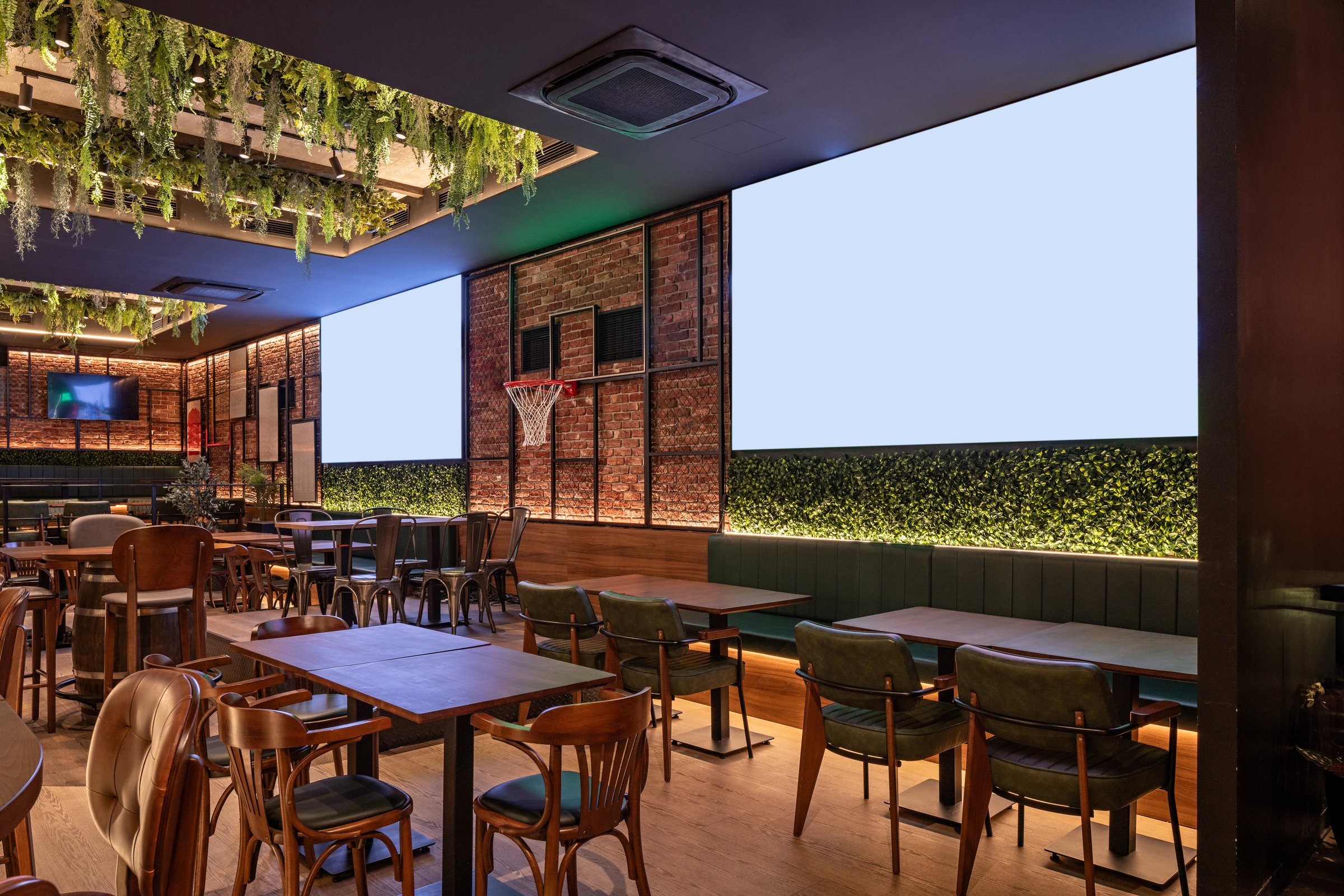 Warm sports café interior with brick décor and numerous TV displays