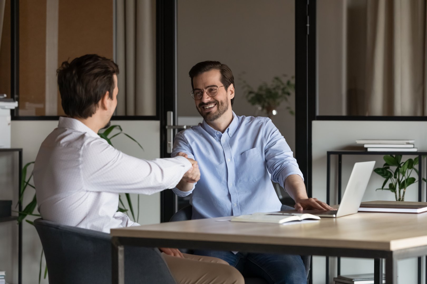 Employer, boss hiring candidate after successful job interview. Happy customer and lawyer, finishing consultation, meeting, shaking hands. Happy business men giving handshakes after negotiations