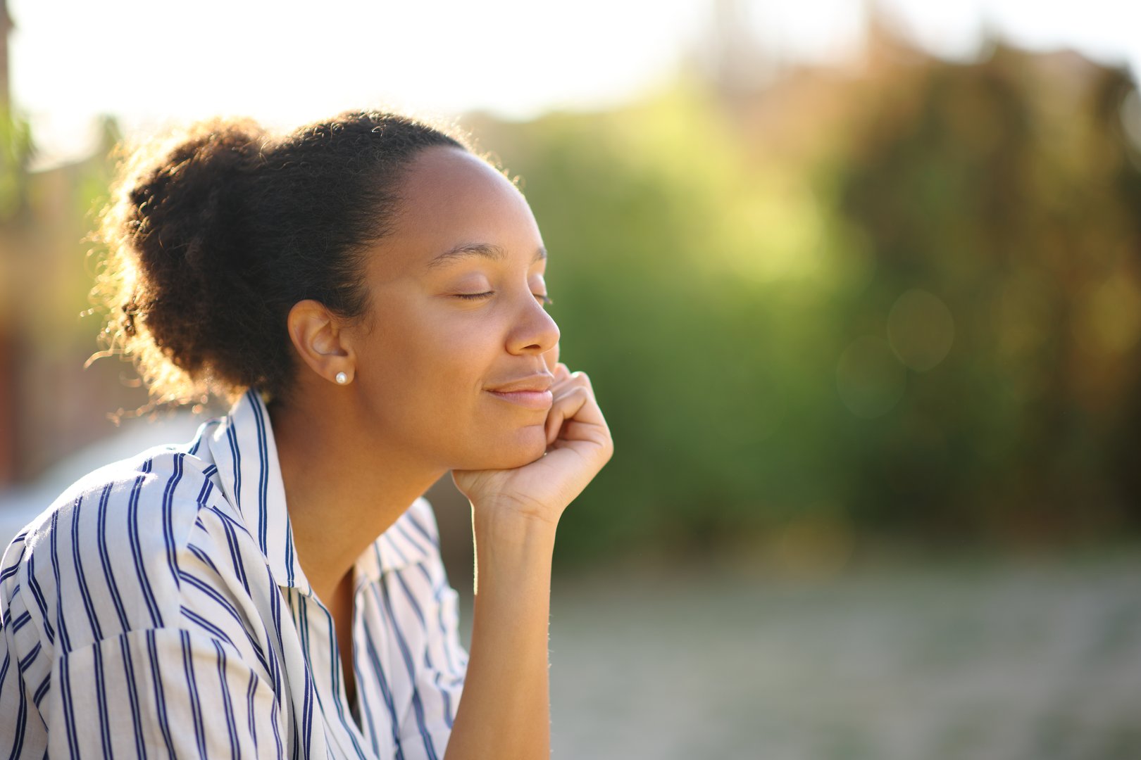 Black relaxed woman resting in a park