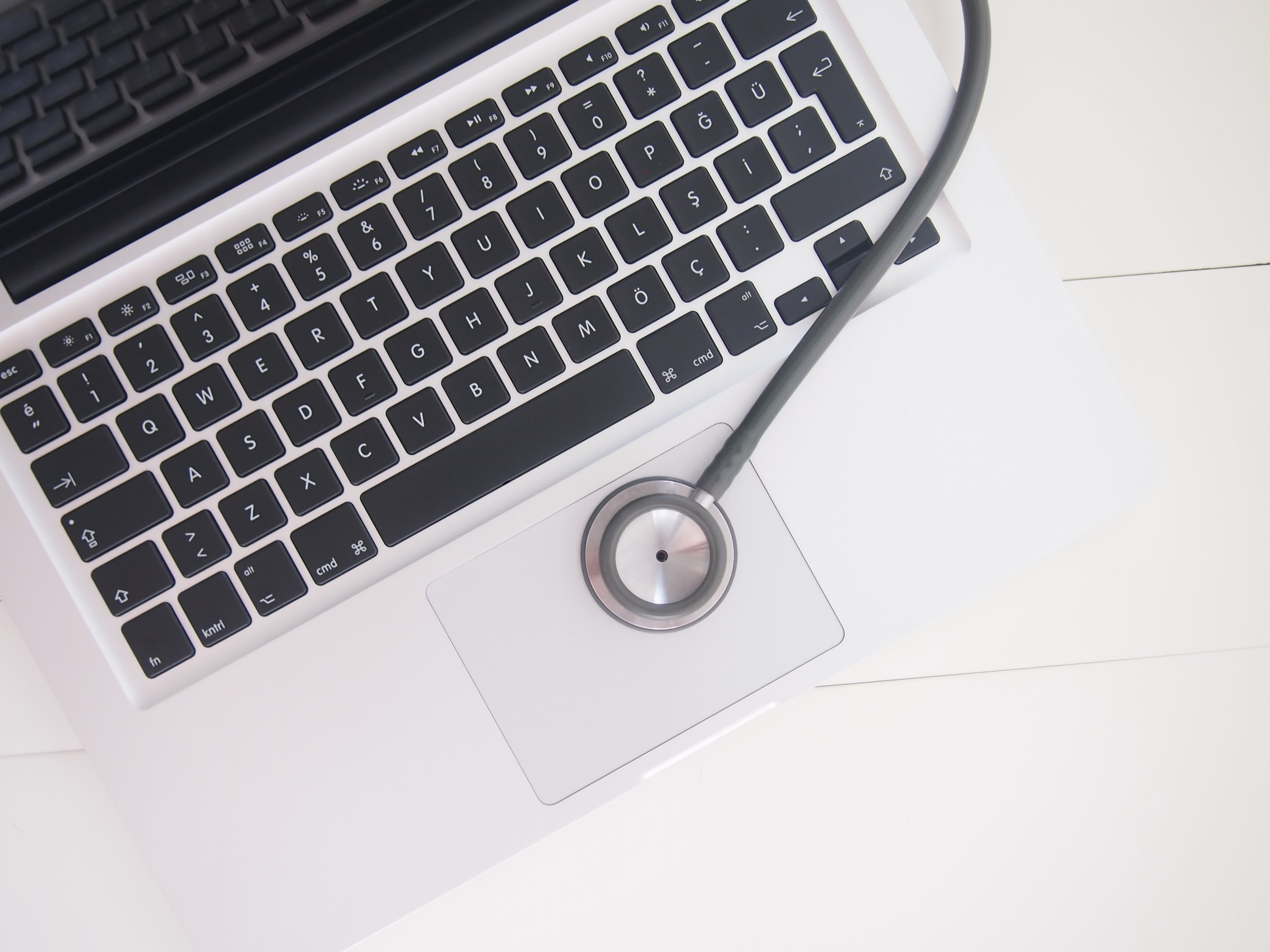 İzmir, Turkey - May 01 2015: Stethescope on macbook Pro with white background.