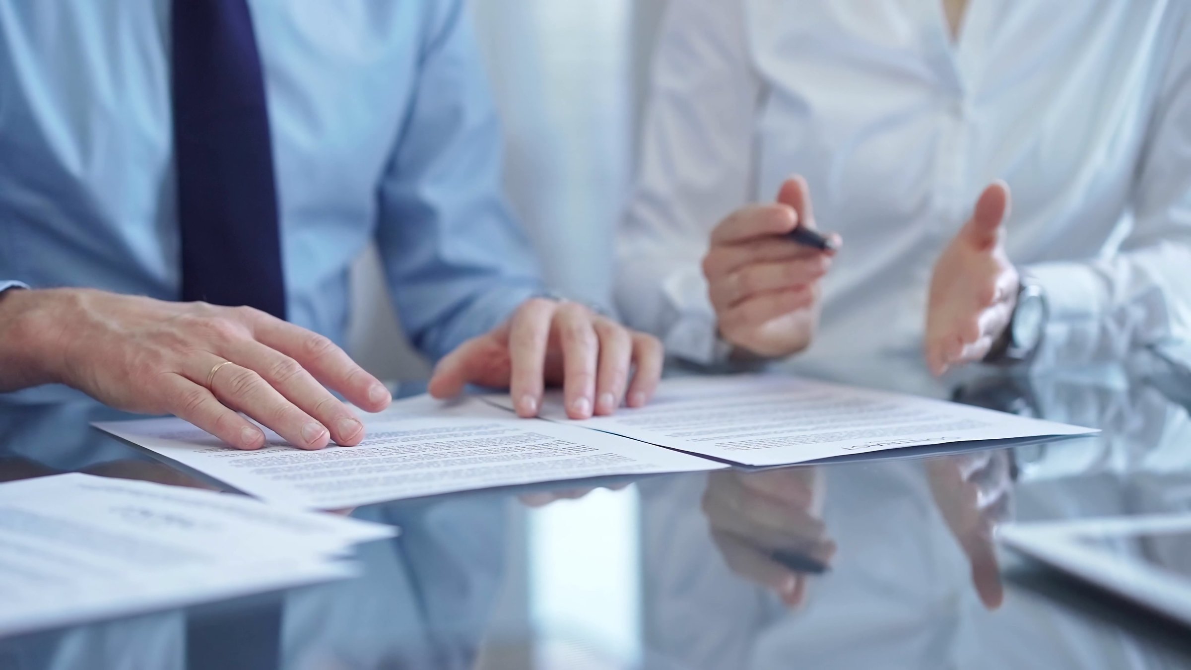 Diverse business people discussing contract papers before signing. Teamwork of lawyers are at work in office.