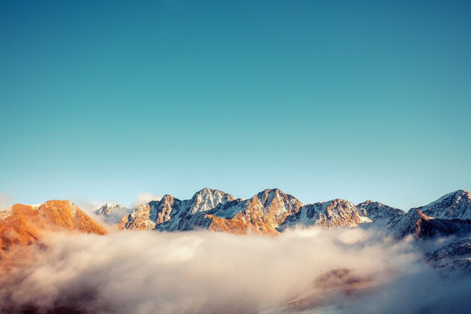 Mountains minimalist landscape. Peaks of the mountains above the clouds. Pyrenees, Andorra, Europe
