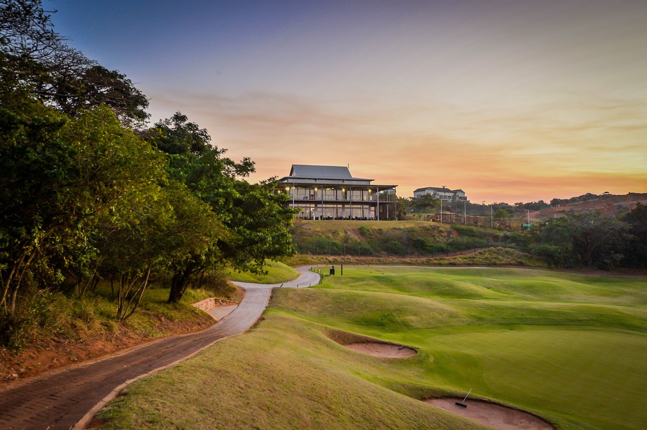 Simbithi Country Club golf course with lush green fairways and ocean views