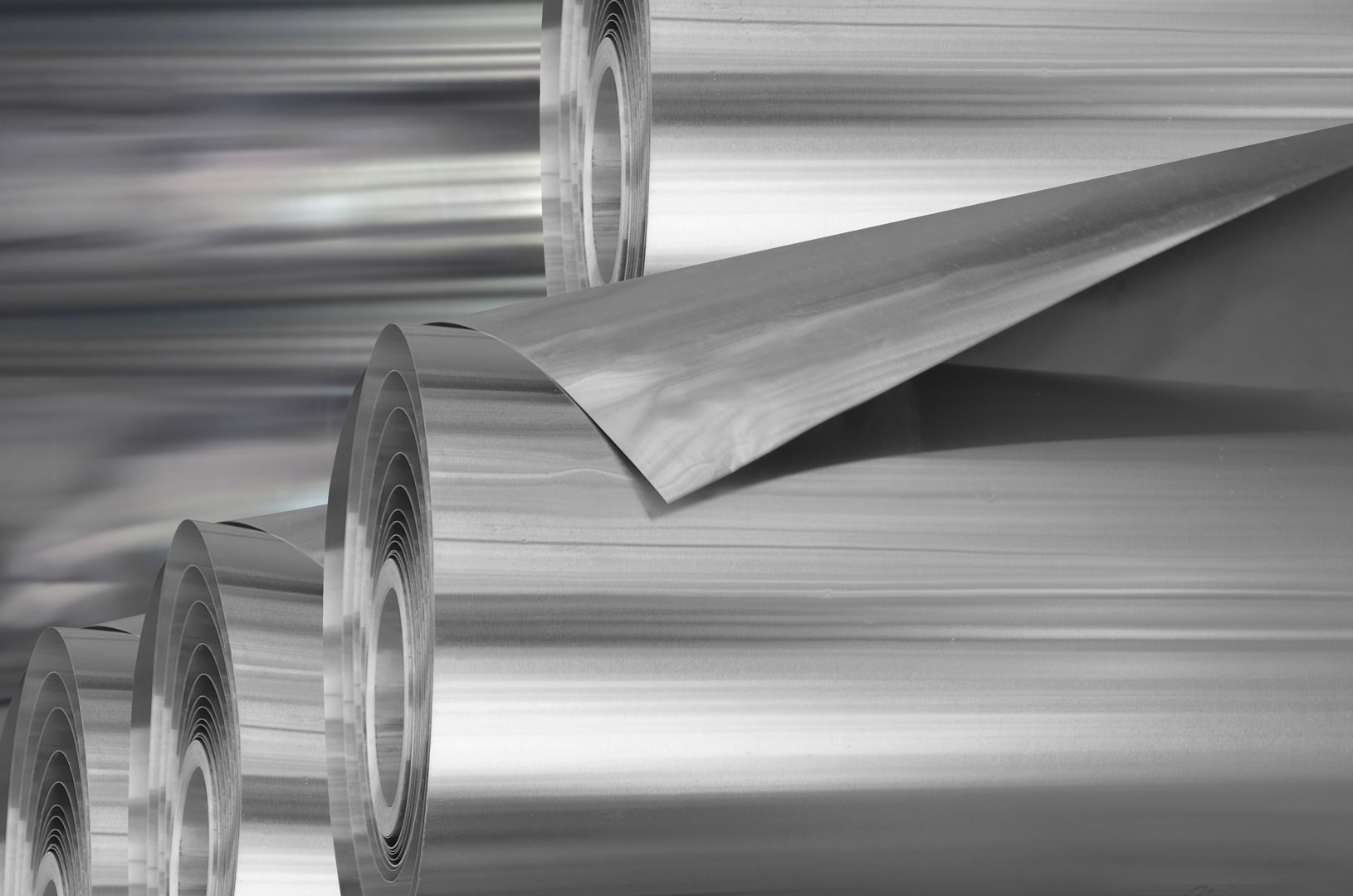 pile of thin aluminum rolls. industrial stock. selective focus