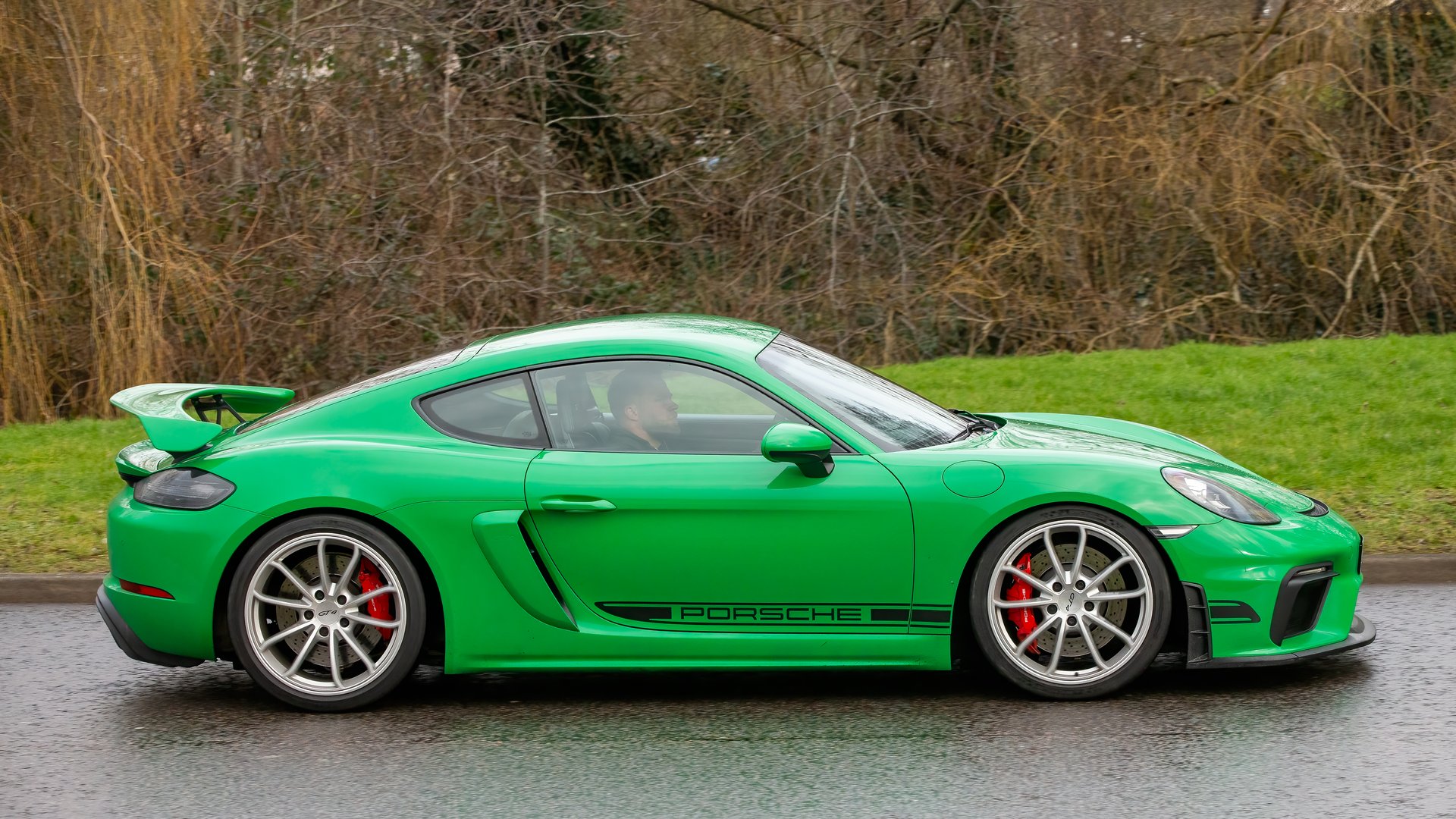 Milton Keynes,UK - Feb. 16th  2025:  2020 green Porsche 718 Cayman GT4  car driving on a British road.