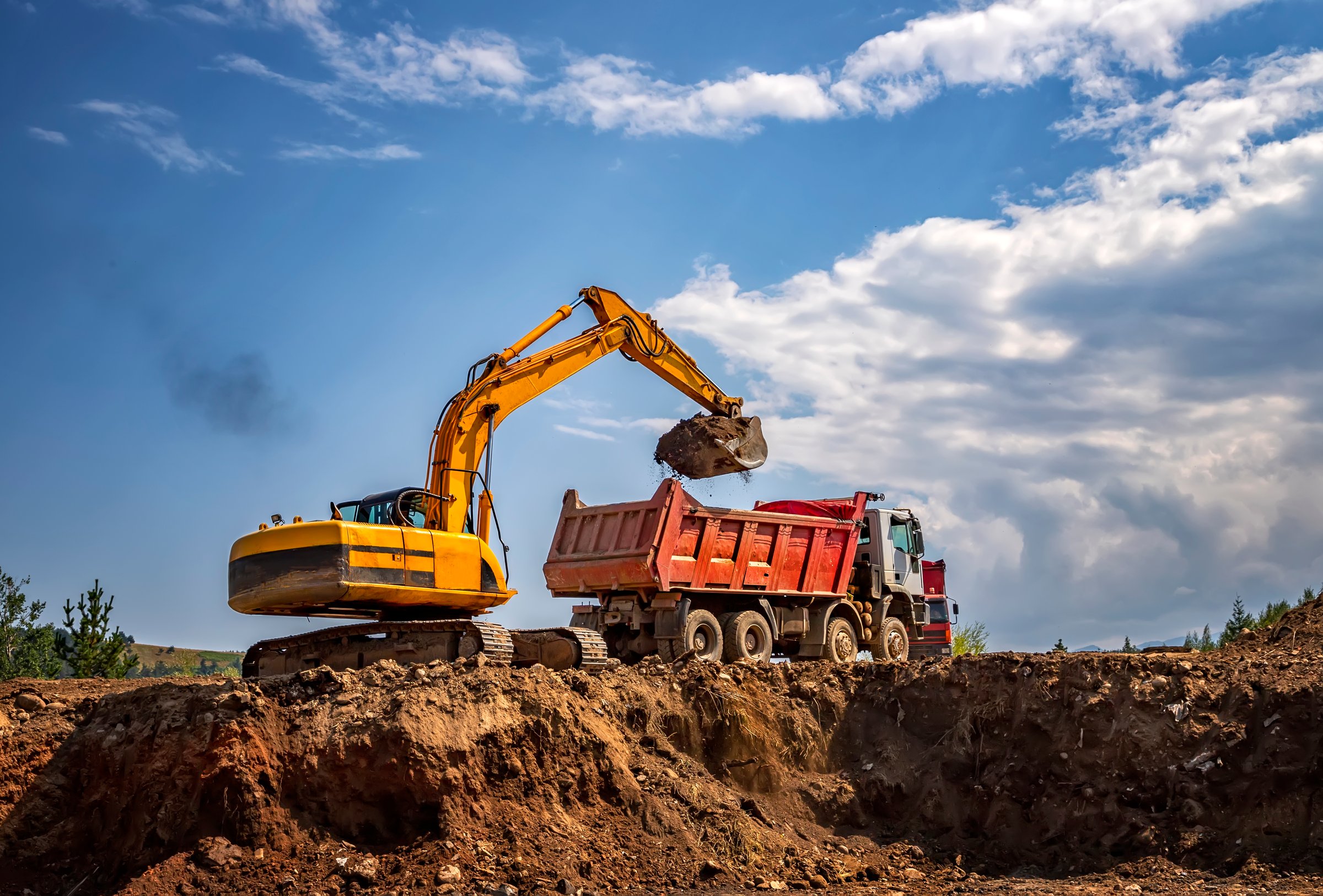 Construction Heavy Equipment Trucks on Site