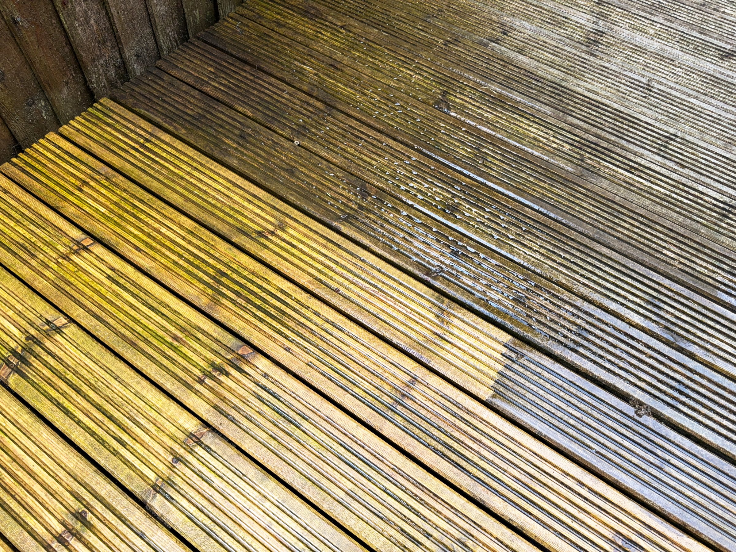Before and after view of dirt and grime being cleaned from wooden decking using a pressure washer