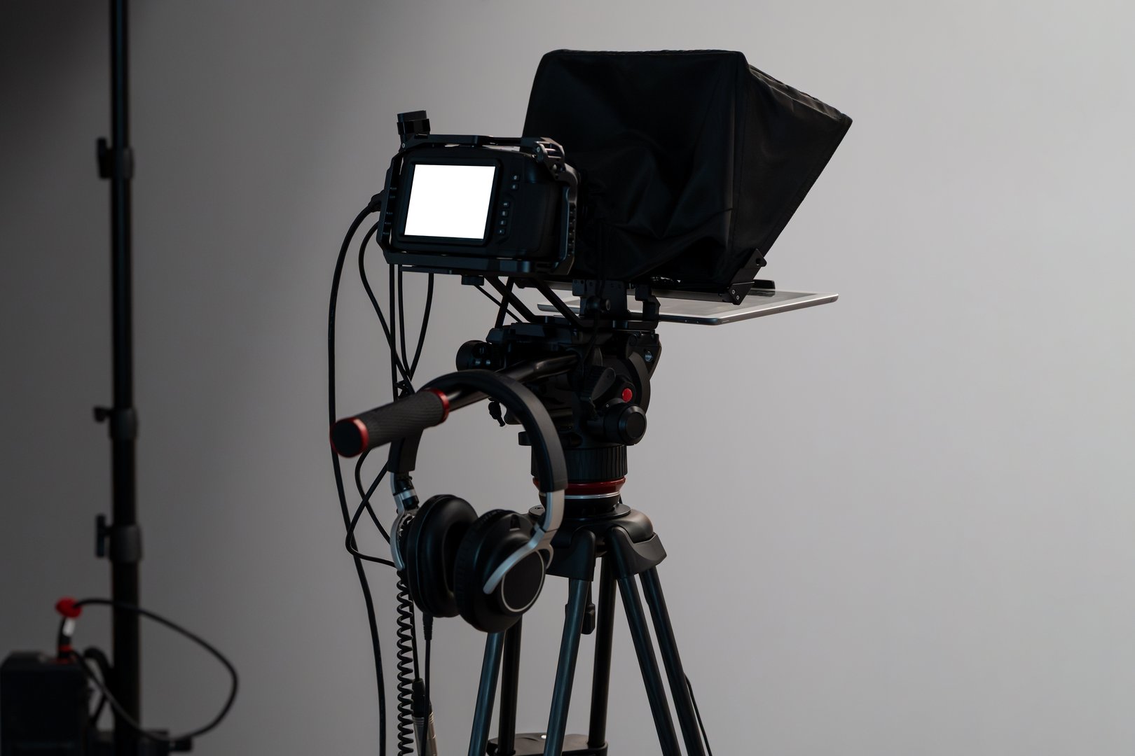 Video camera setup in a studio with a blank display screen. Professional equipment for audiovisual media production. Video shoot for social media and content creation. Behind the scenes template.