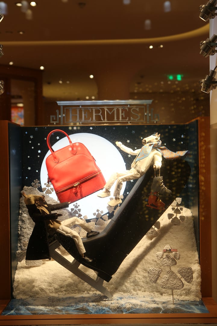 Moscow, Russia - January 9, 2021: Creative show window, store display of Hermes boutique shop in GUM department store in Moscow city (State Department Store). Neon art in show windows. Hermes fashion.