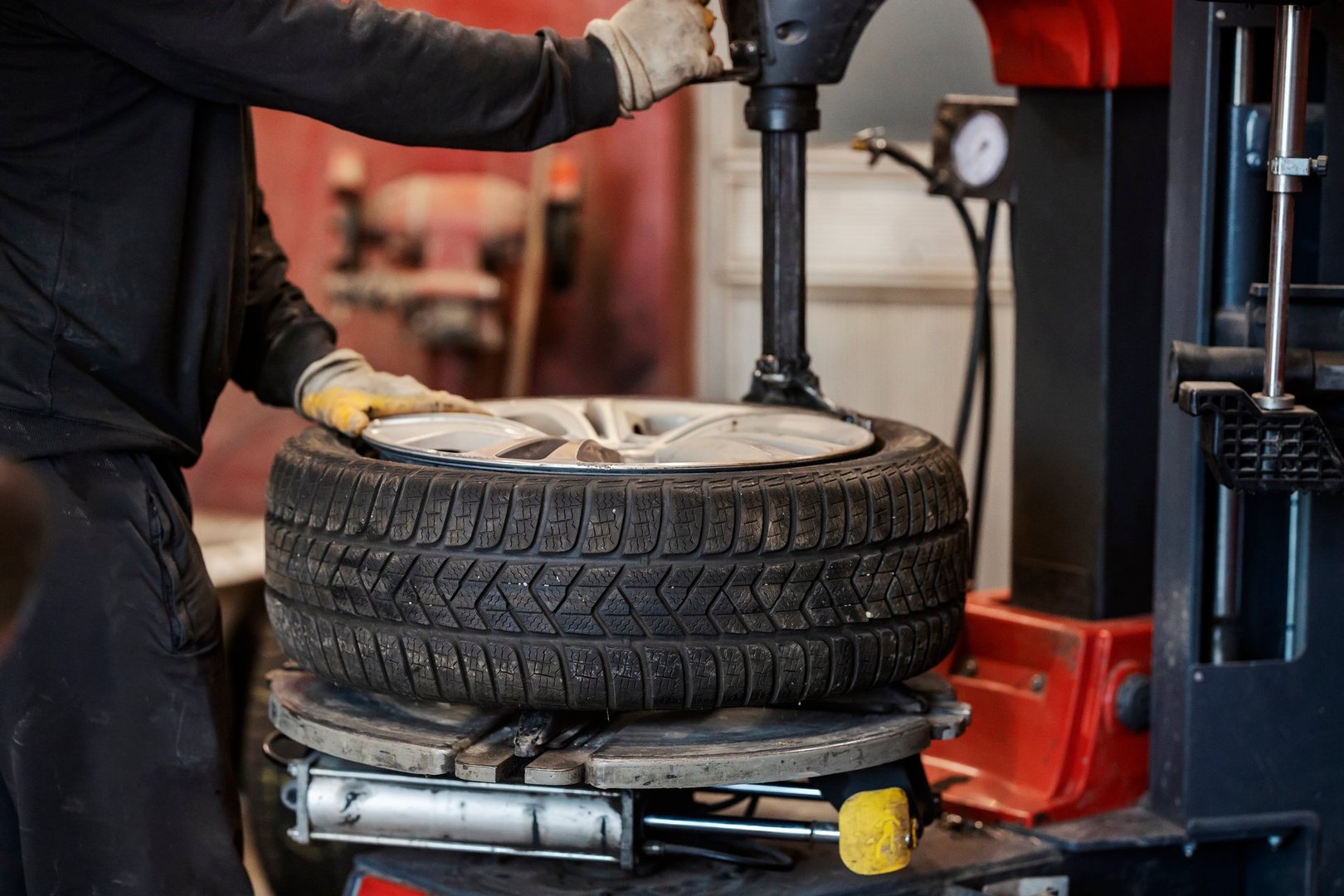 Cropped picture of mechanic service worker working with vulcanizing equipment at vulcanizing workshop.