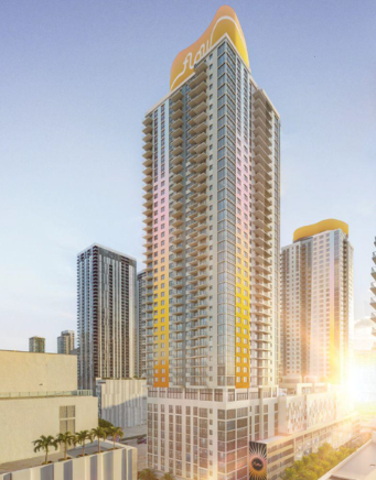 Skyscraper with orange accents and balconies, surrounded by other tall buildings, under a clear sky.
